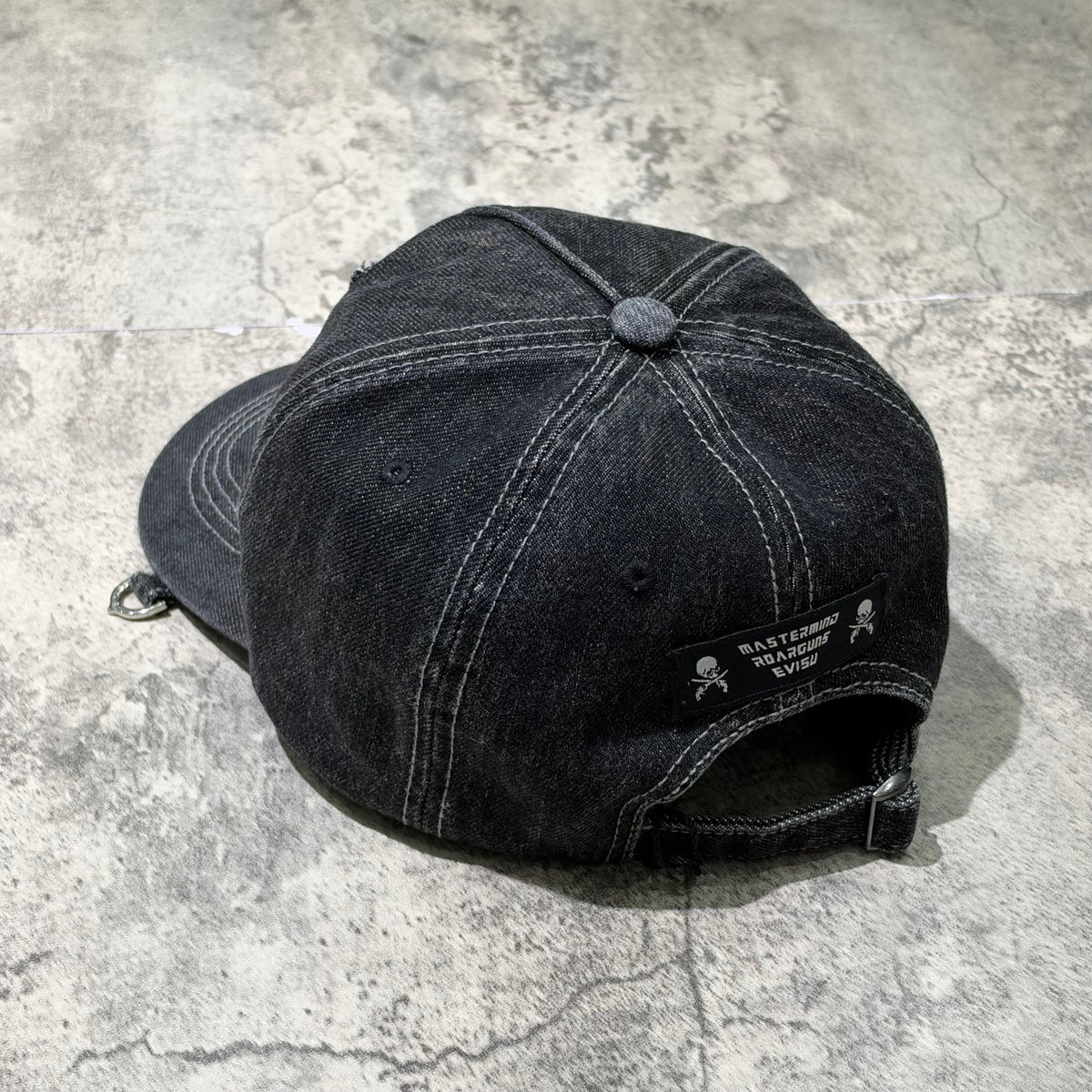 Evisu x Mastermind Japan x Roarguns Cap featuring a stylish black denim design and logo detailing.