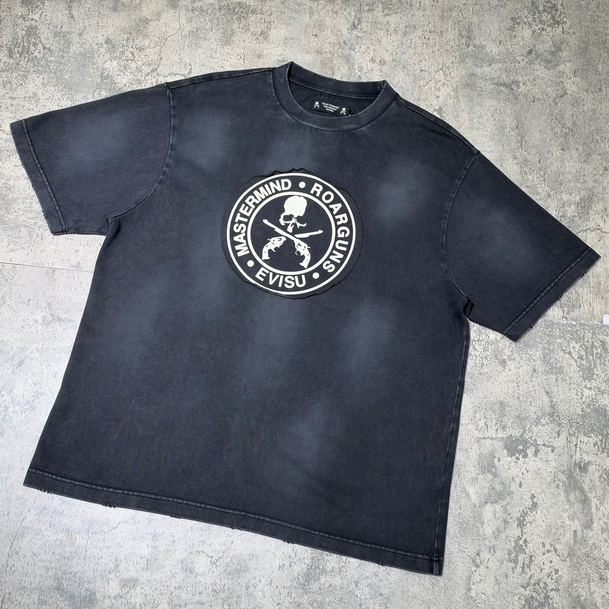 Evisu x Mastermind Japan x Roarguns Tee featuring a bold graphic logo on a black oversized shirt.