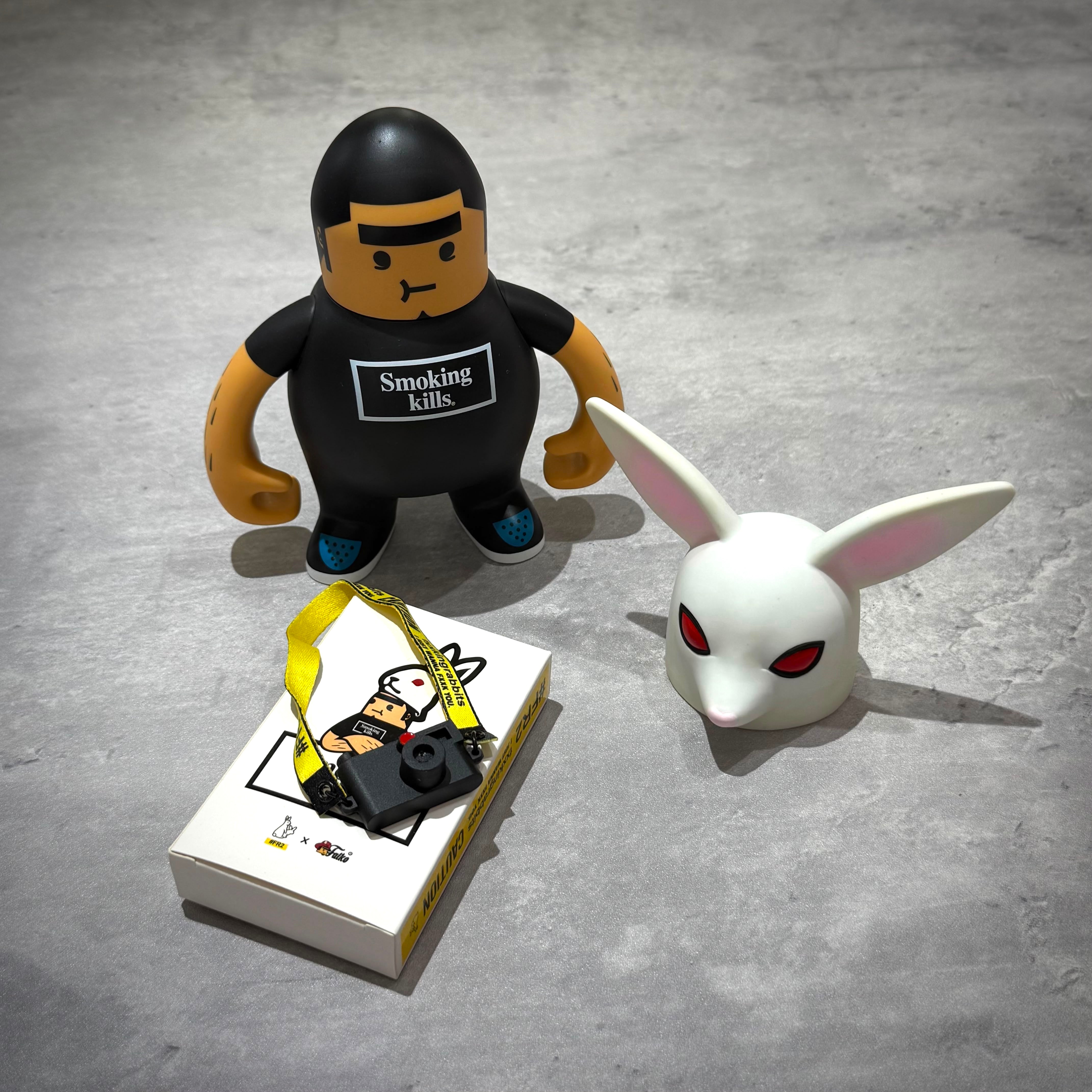FR2 Fatko X FR2 Figure Doll - White/Black showcasing a figure with a camera and rabbit head.