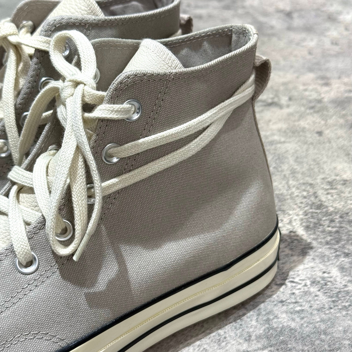 Fear Of God Essentials x Converse Chuck 70s Hi in White / Grey with laces and canvas material close-up.