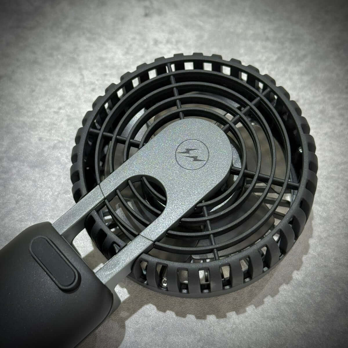 Fragment Design x Cado Mini Handy Fan, close-up view from above showcasing the sleek design and airflow mechanism.