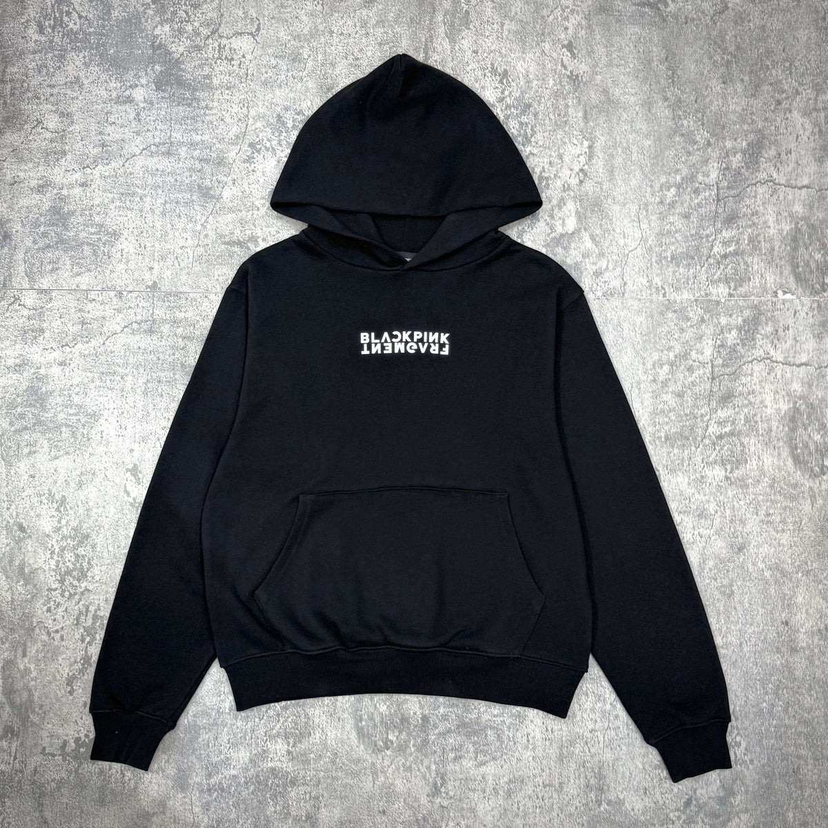 Fragment x Blackpink Thunder Hoodie in black with front pocket and logo design on chest.