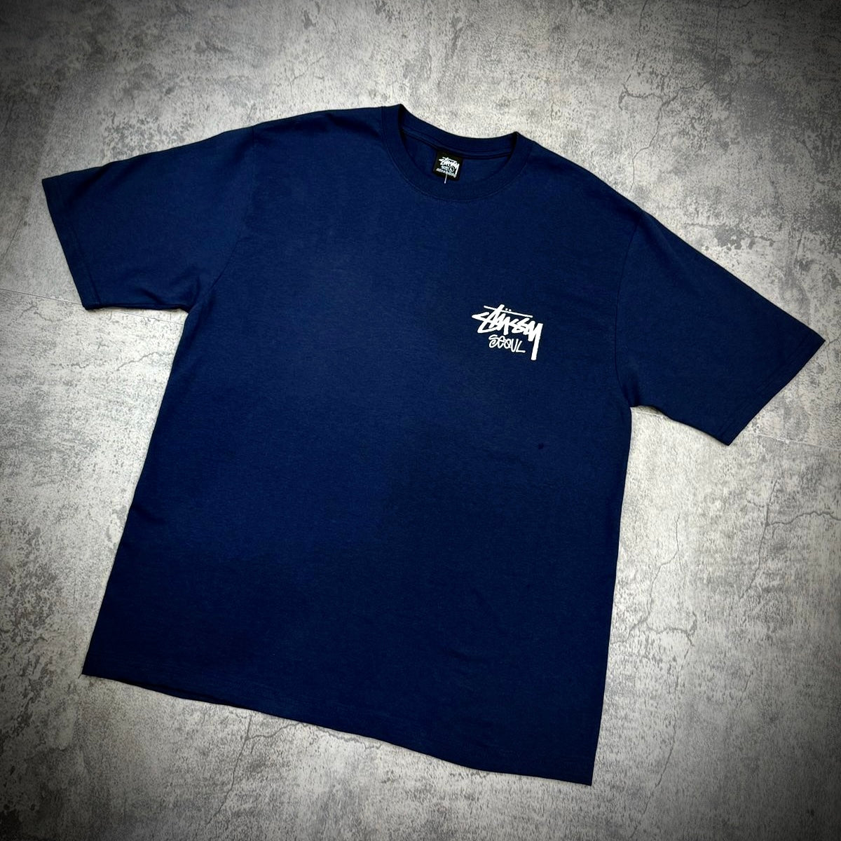 Stussy Seoul Exclusive Logo Tee in navy color featuring a white logo design on the chest.
