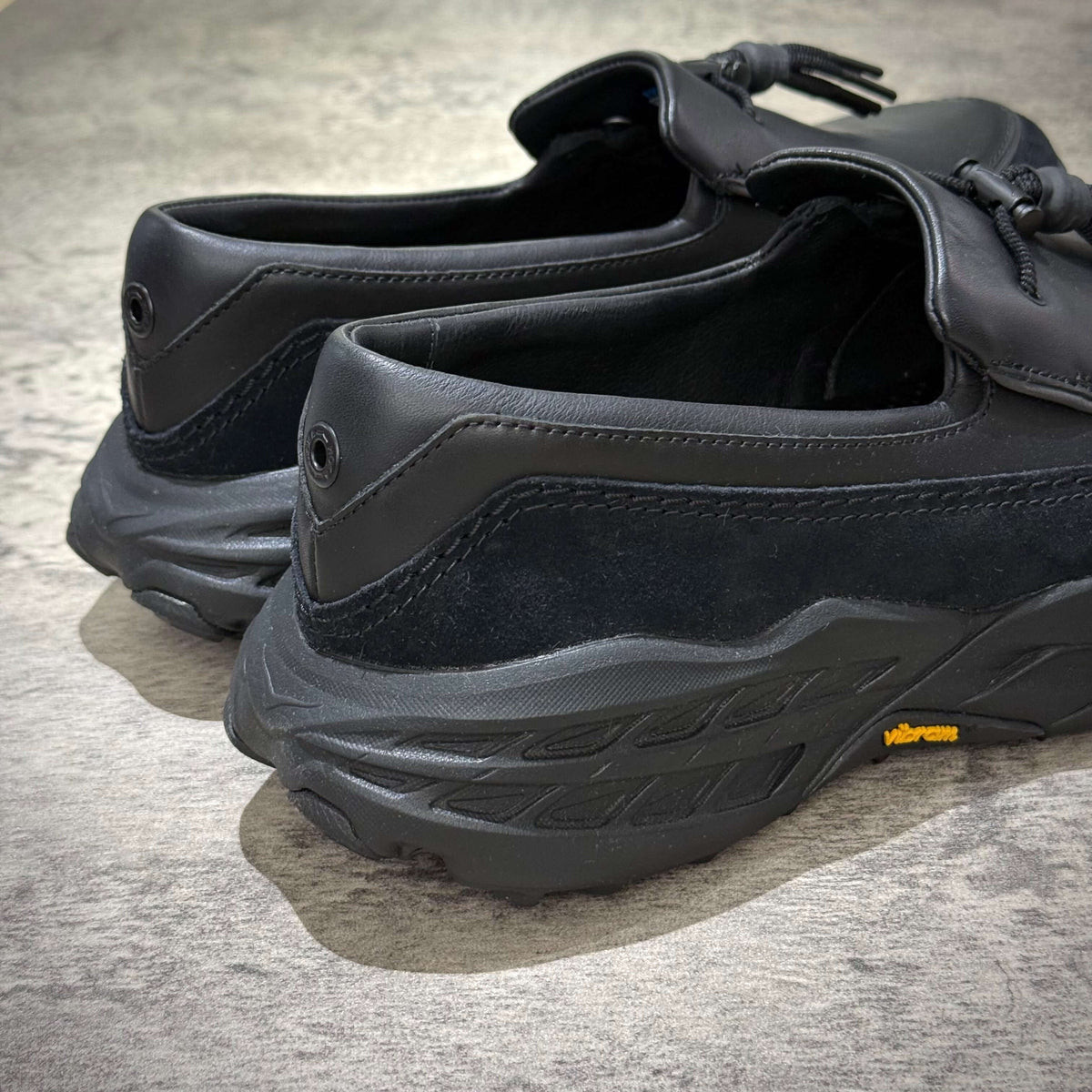 Hoka Speed Loafers - Black 1162170-BBLC showing the side view and textured sole design.
