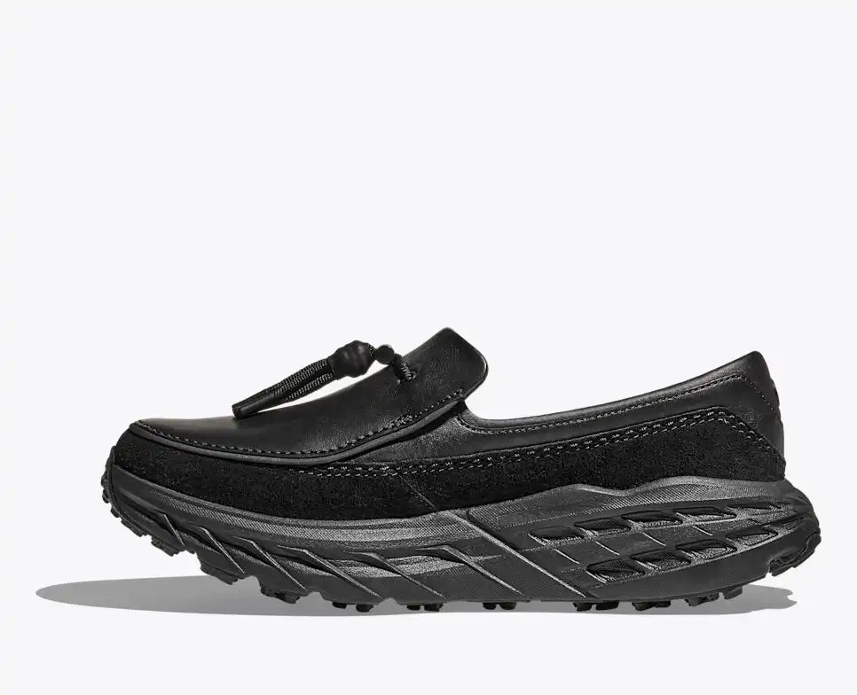 Hoka Speed Loafers - Black 1162170-BBLC side view showcasing stylish design and rugged traction.