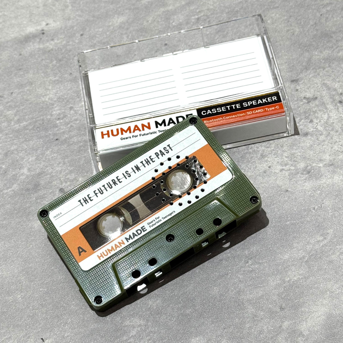 Human Made Cassette Speaker featuring retro design with a green cassette and clear packaging.