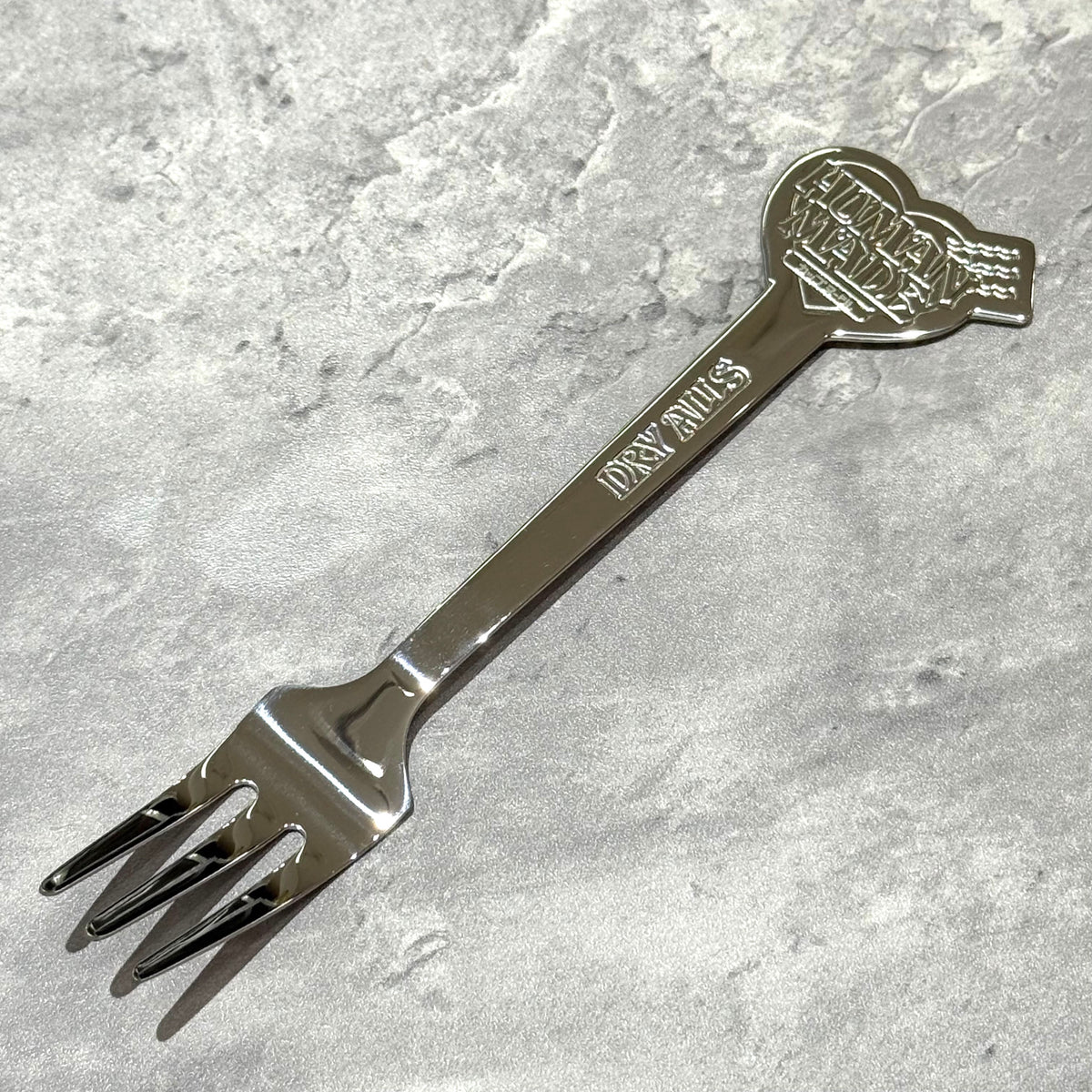Human Made Cup Noodle Fork featuring a sleek design and embossed logo, ideal for enjoying Japanese convenience food.