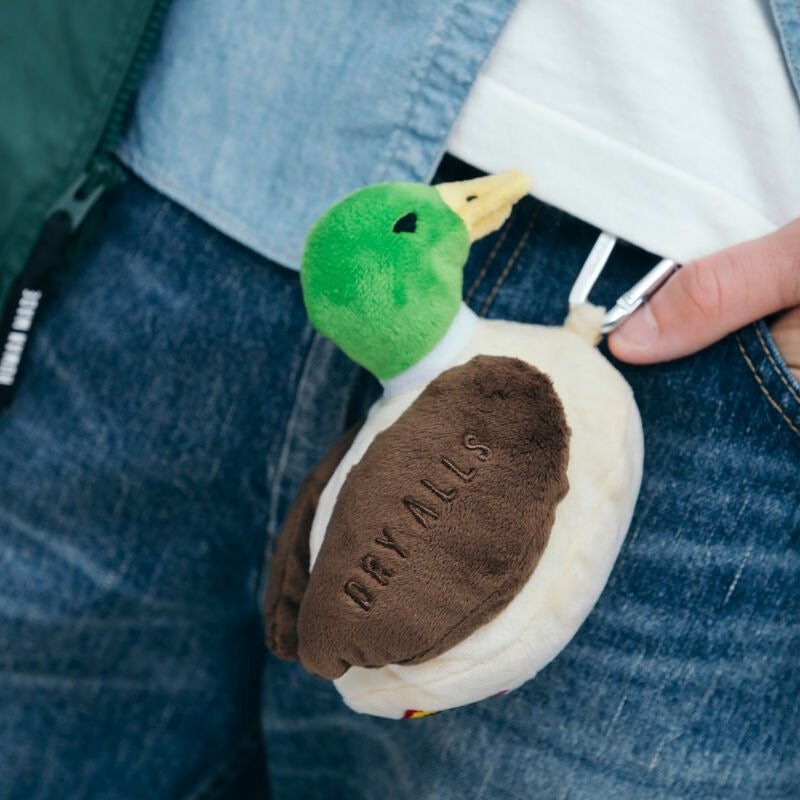 Human Made Duck Plush Pouch clipped to a person's waistband, showcasing its cute duck design.