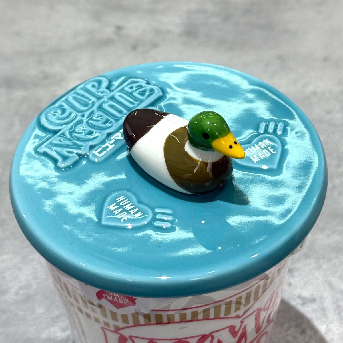 Human Made Lid Holder featuring a duck design on top of a Cup Noodle container.
