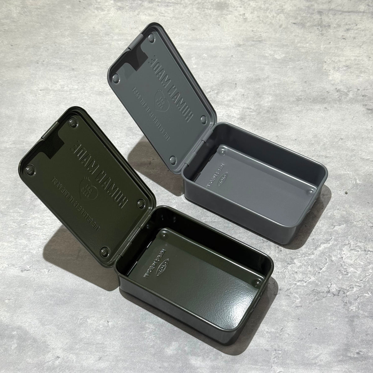 Human Made Steel Tool Box in two colors, open with lids, showcasing vintage industrial design and practical utility.