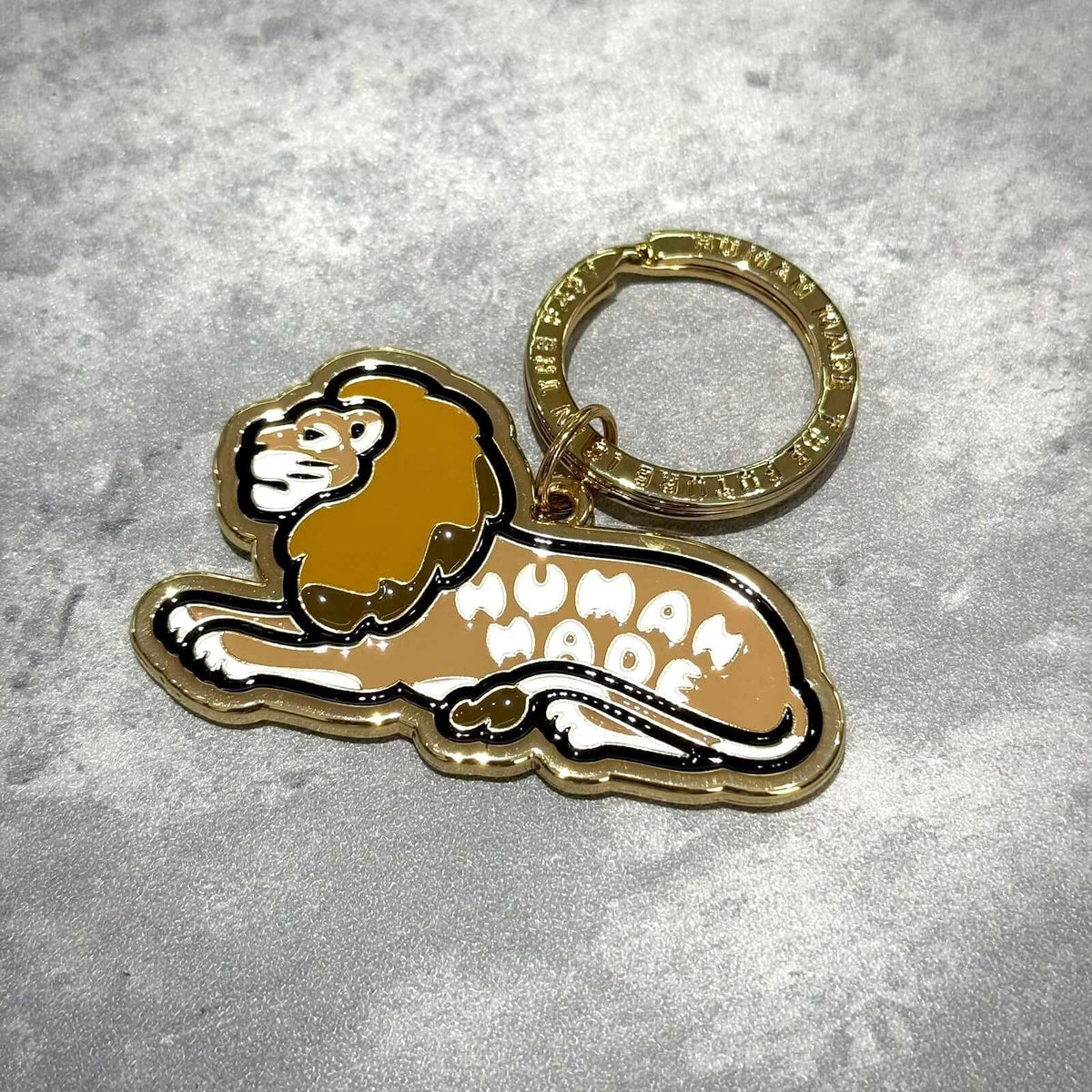 Human Made Tokyo Exclusive Lion Keychain featuring a golden lion design on a keyring.
