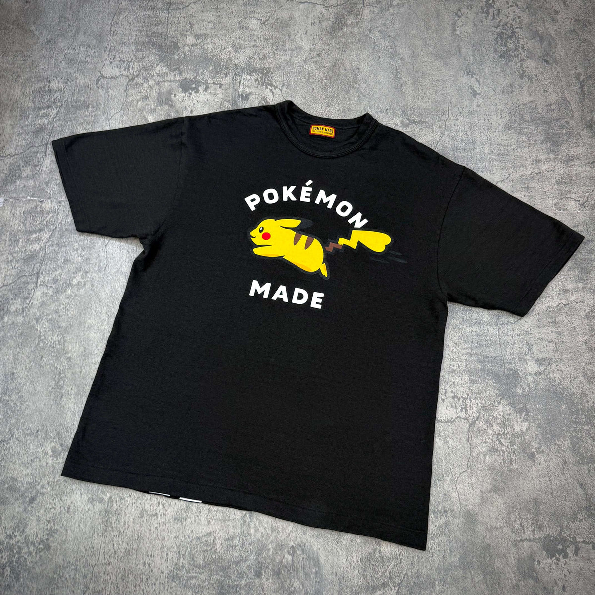 Human Made x Pokemon Graphic Tee featuring Pikachu with bold text on a black background.