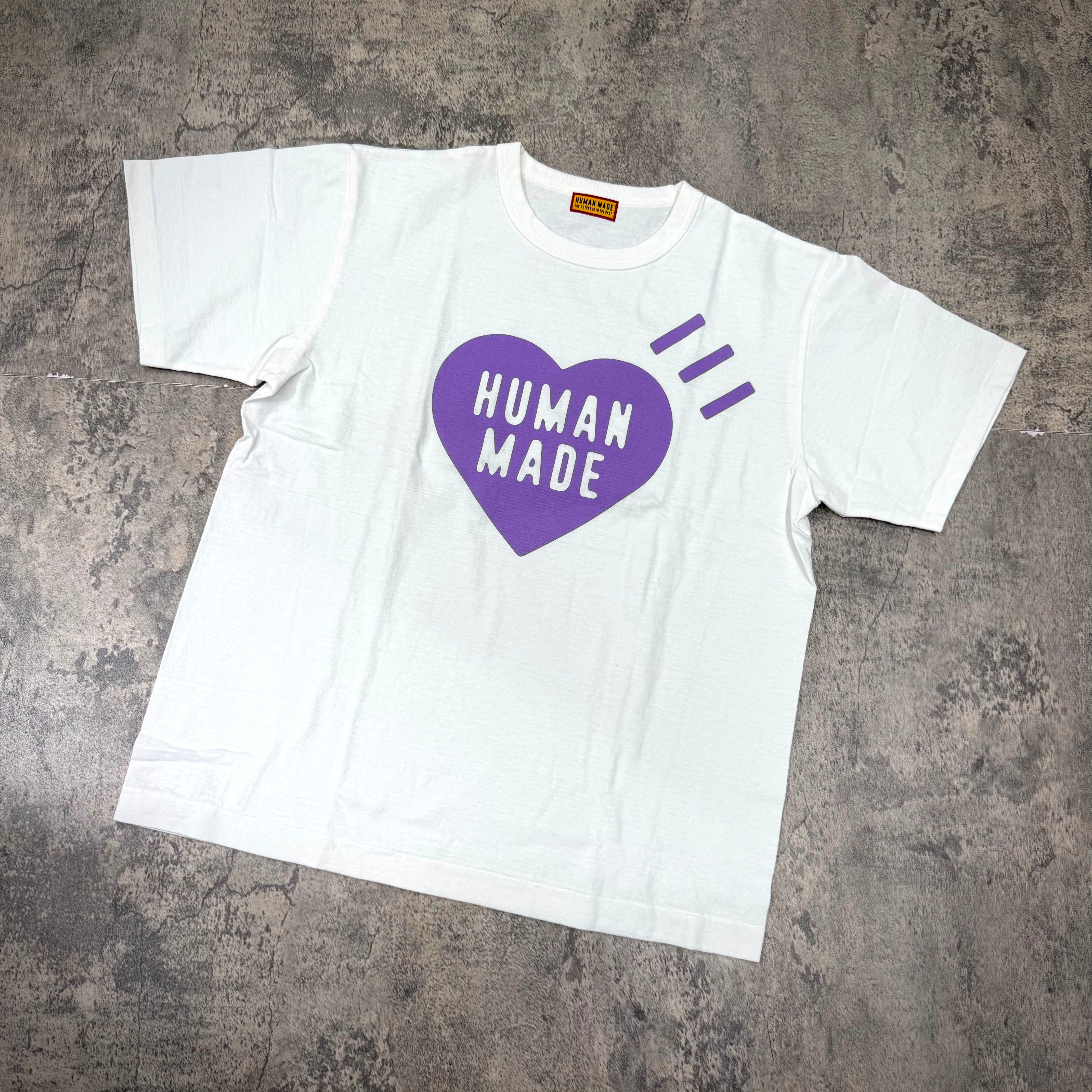 Human Made Apgujeong Exclusive Heart Logo Tee displayed on a gray floor background.