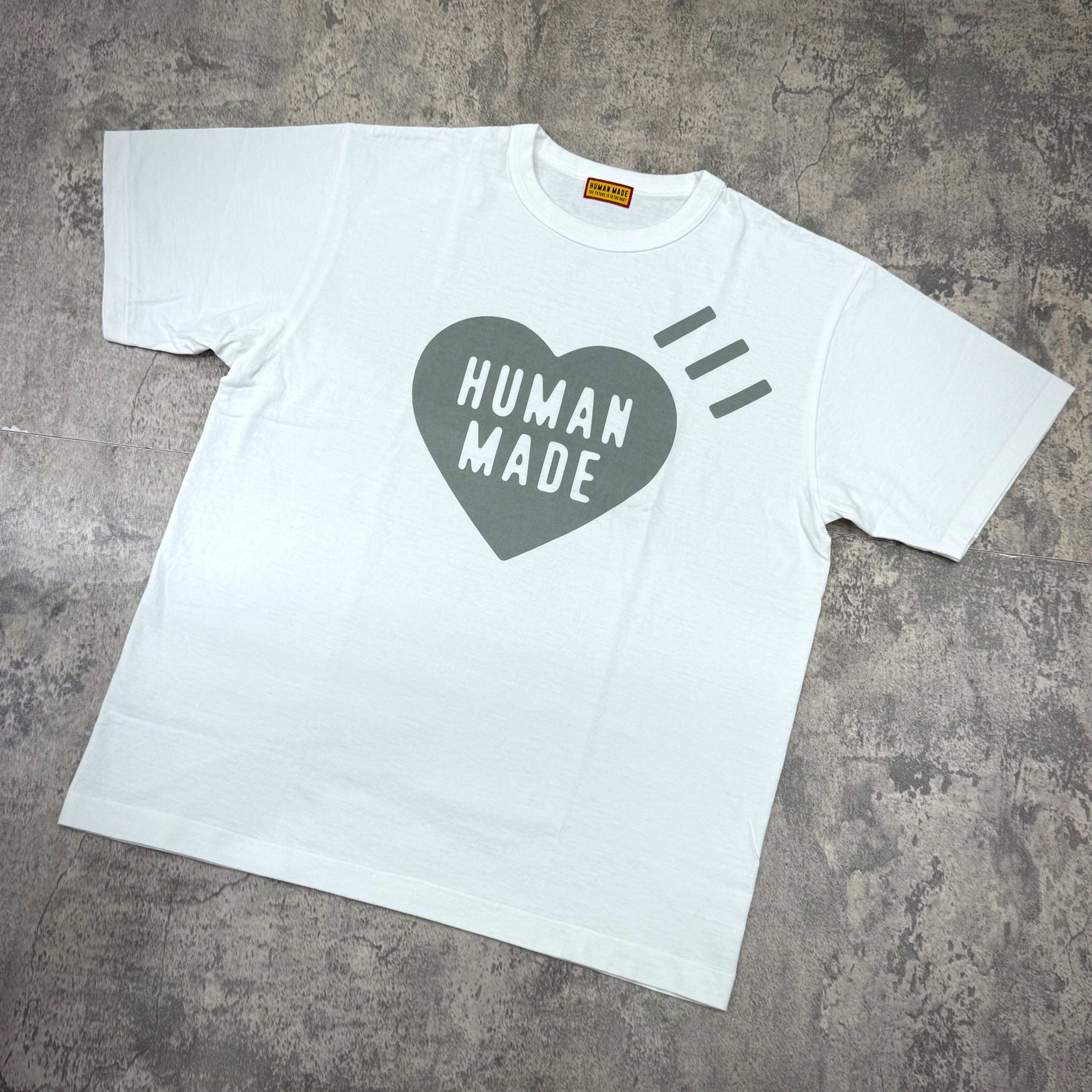 Human Made Sapporo Exclusive Heart Logo Tee displayed on a textured surface with a heart logo design.