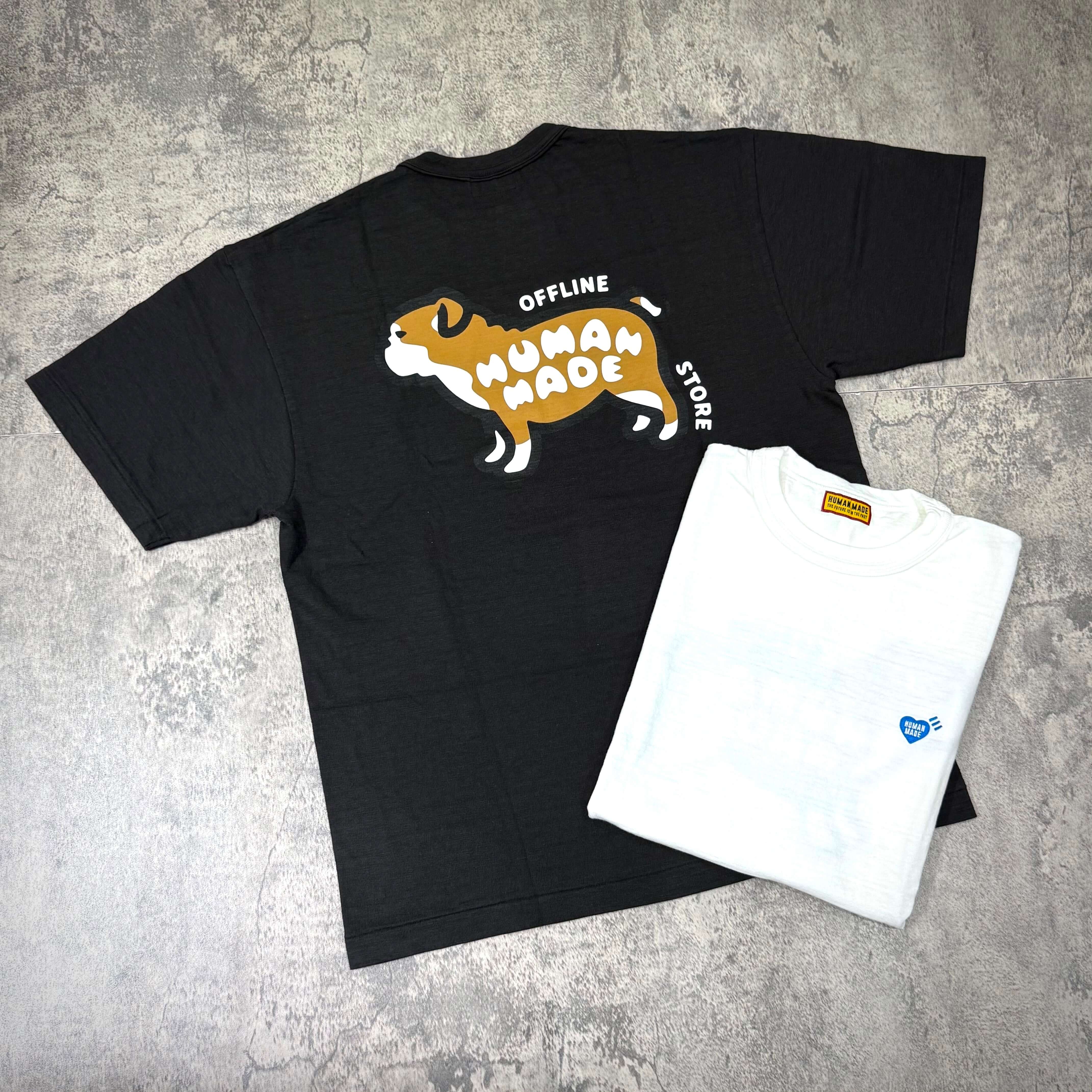 Human Made Gaien offline Exclusive Bull Dog Back Logo Tee displayed with a white tee on a textured surface.