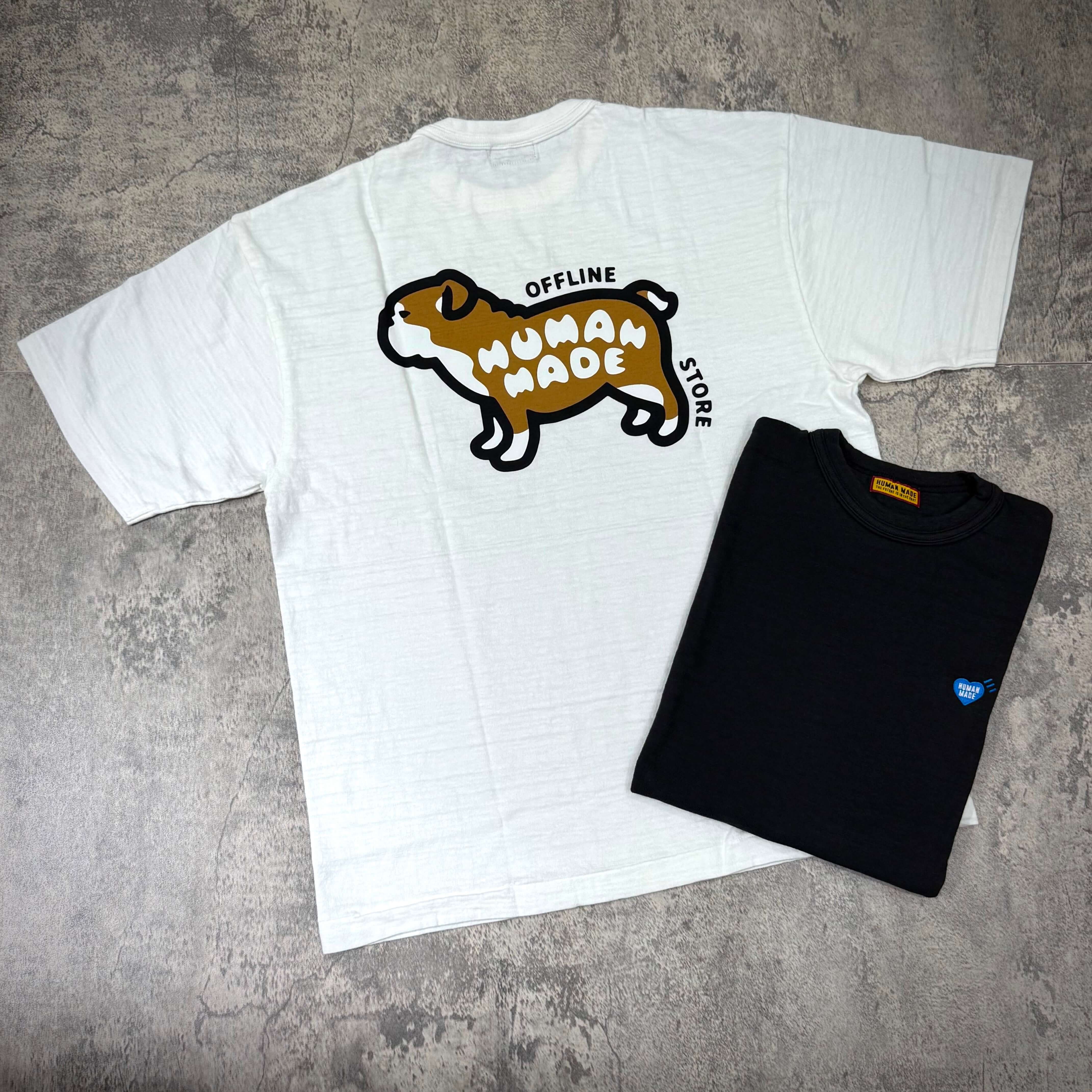 Human Made Gaien offline Exclusive Bull Dog Back Logo Tee displayed with a black tee in a flat lay image.