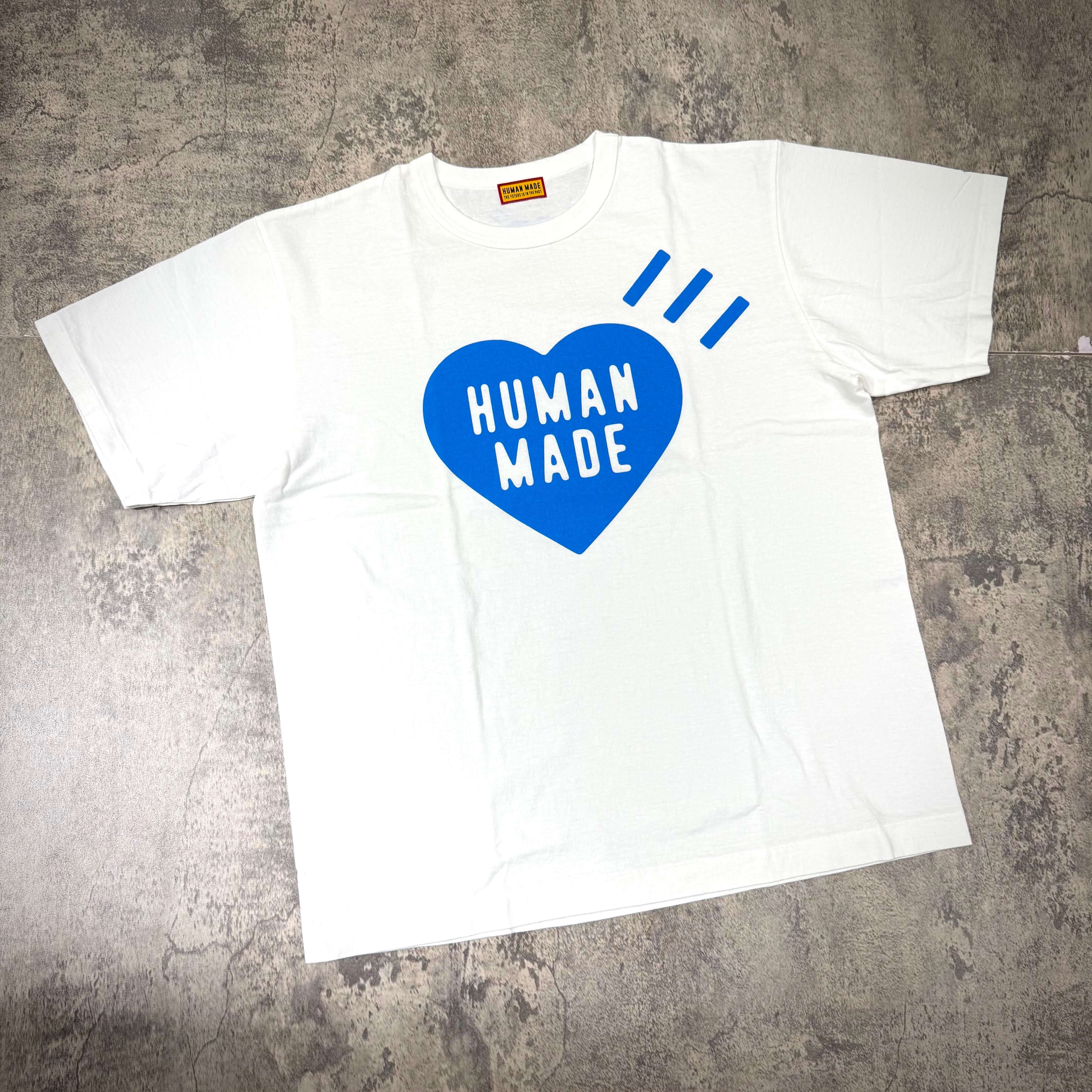Human Made Gaien offline Exclusive Heart Logo Tee displayed on a textured background.