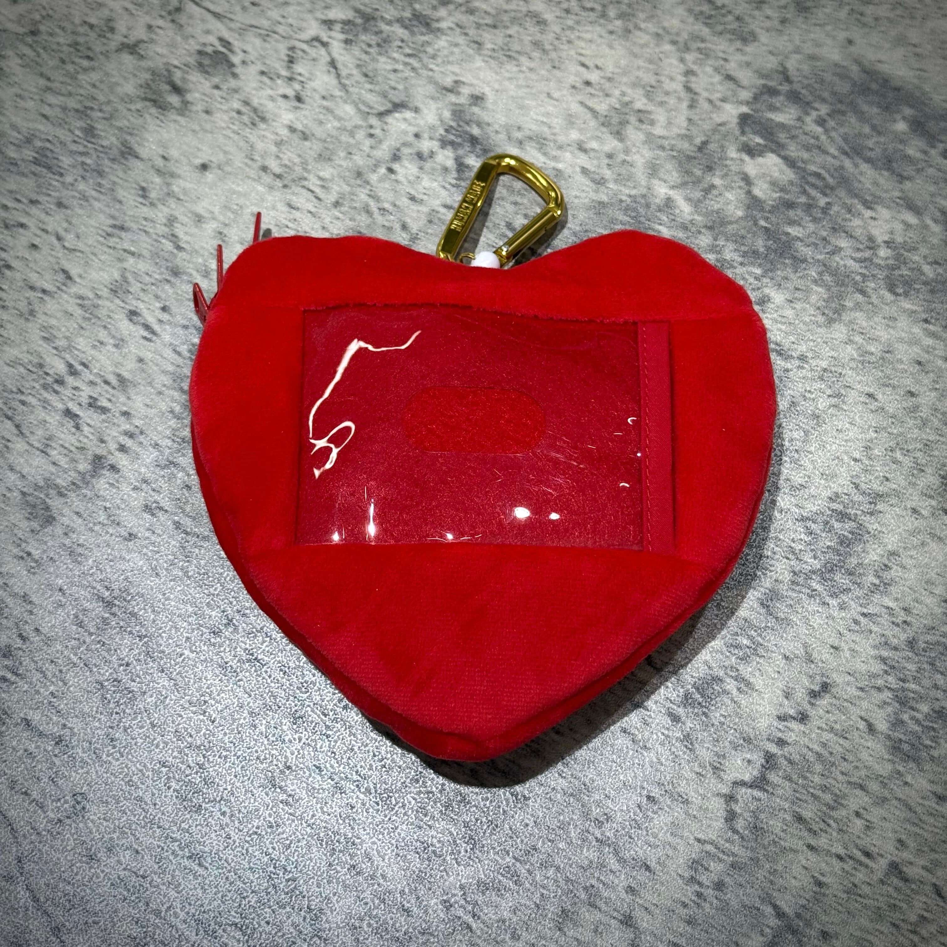 Human Made Heart Pass Case in red with a transparent window and clip, perfect for holding IDs or passes.