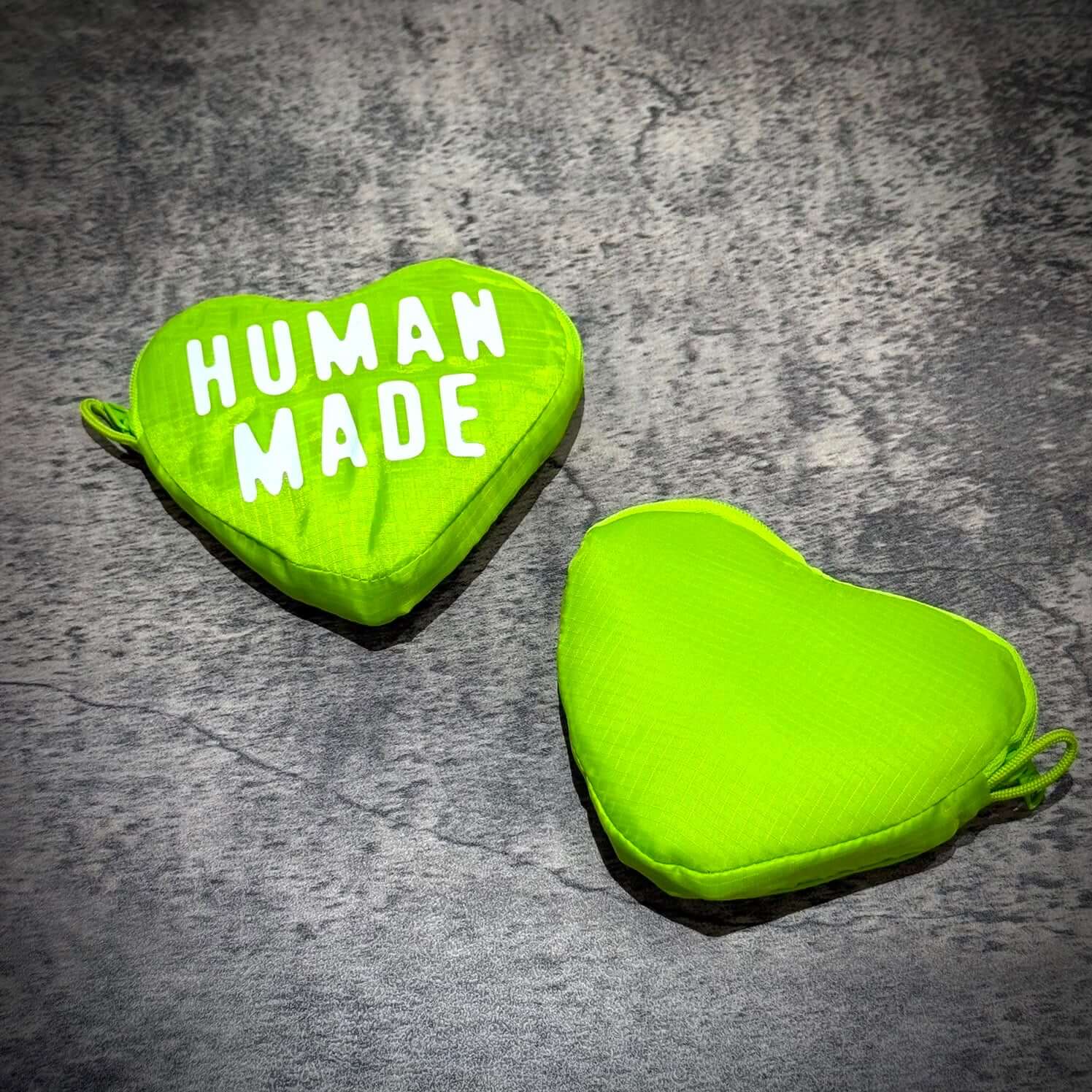 Human Made Heart Shopping Bag in vibrant green color with white lettering on a textured background.