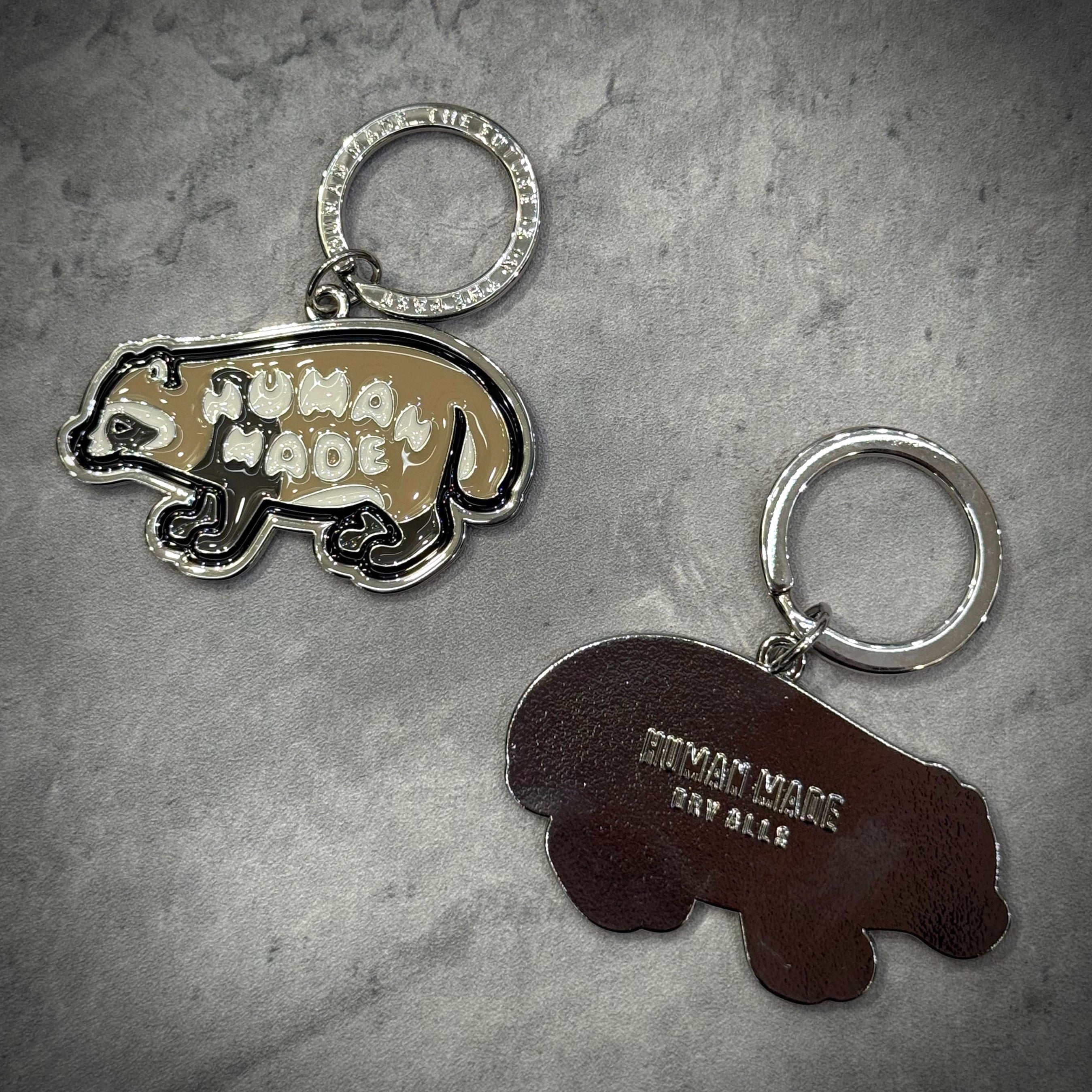 Human Made Jamsil Exclusive Raccon Keychain displayed on a textured surface, showcasing unique designs.