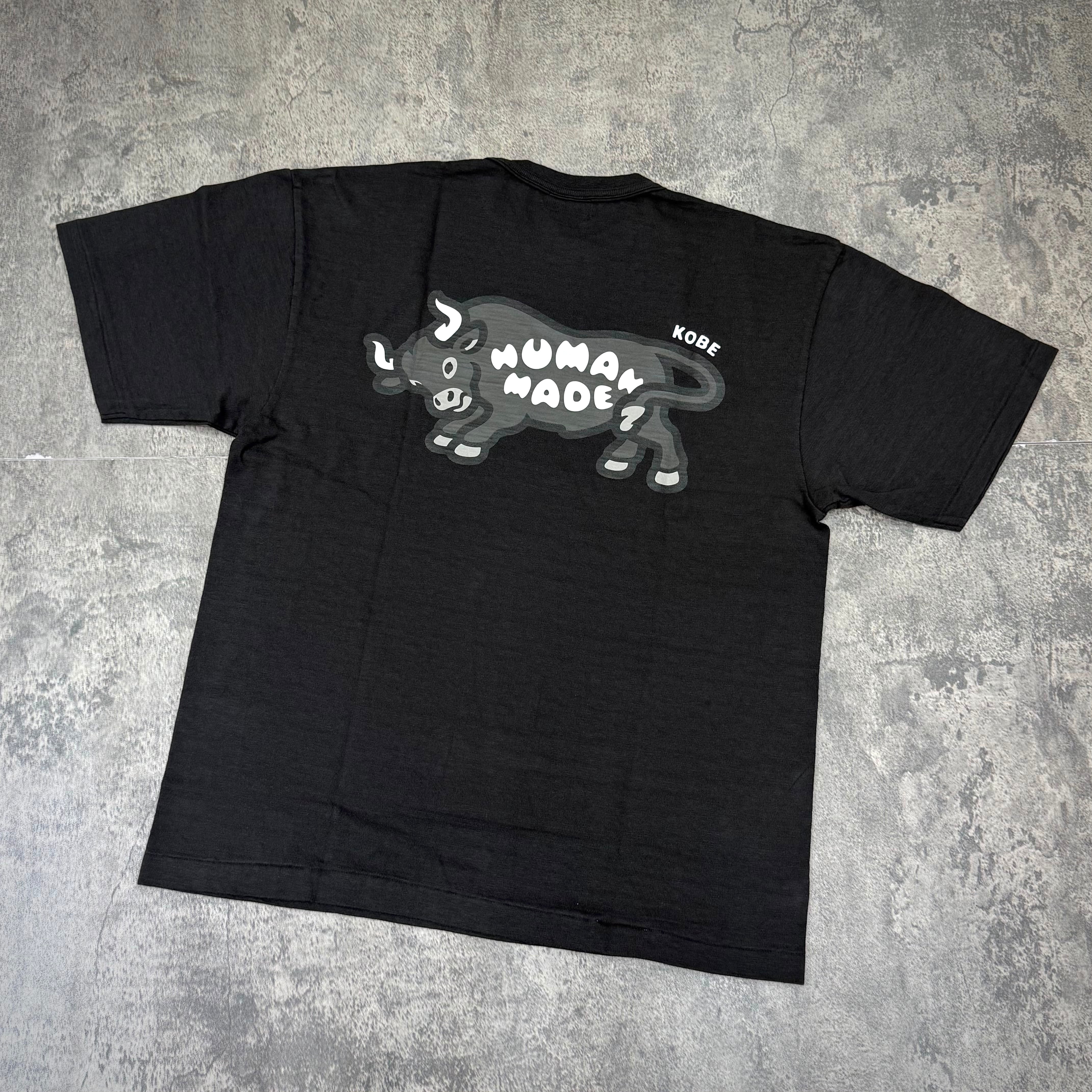Back view of Human Made Kobe Exclusive Bull Back Logo Tee featuring a bull graphic and text on a black t-shirt.