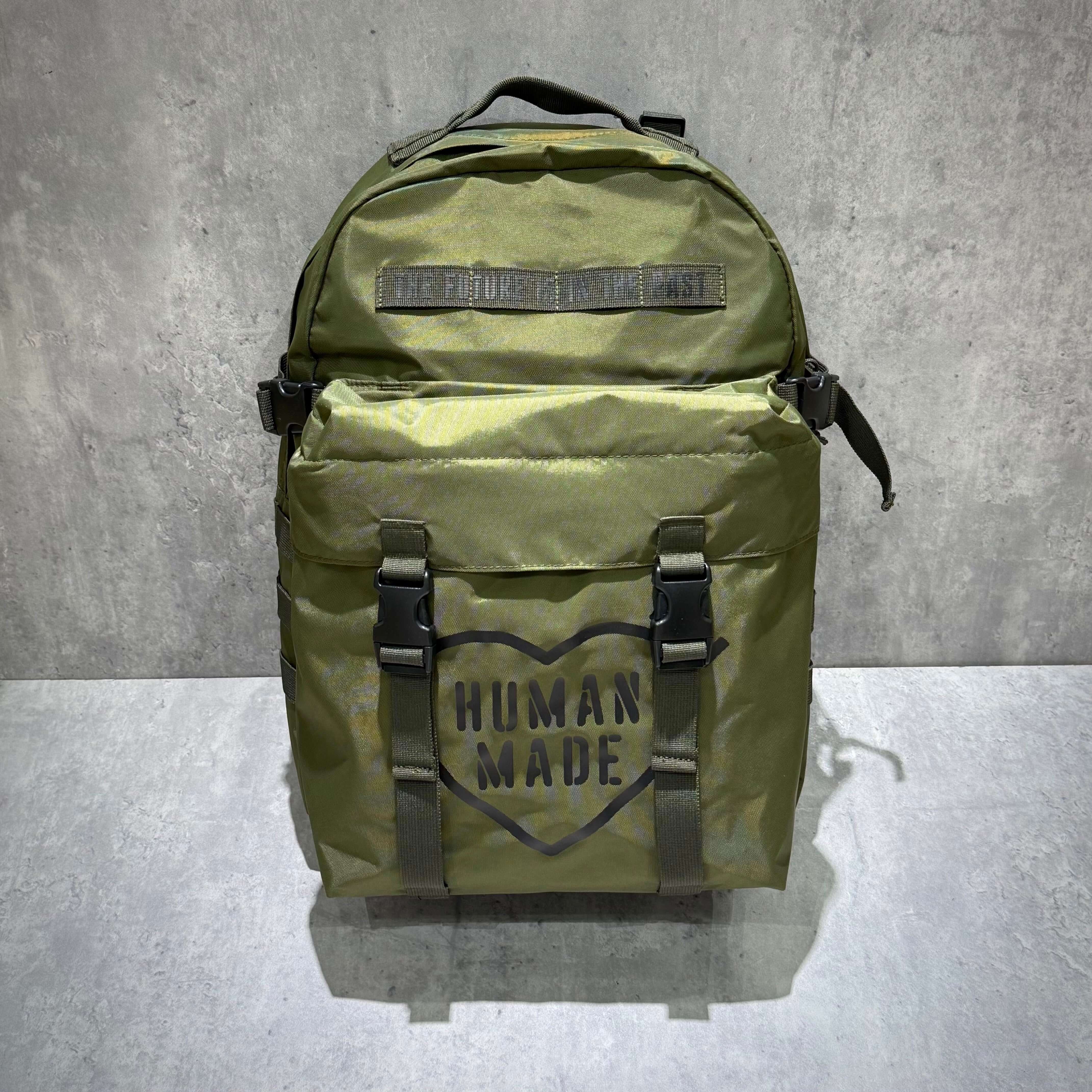 Human Made Military Backpack showcasing olive green design with large logo and straps
