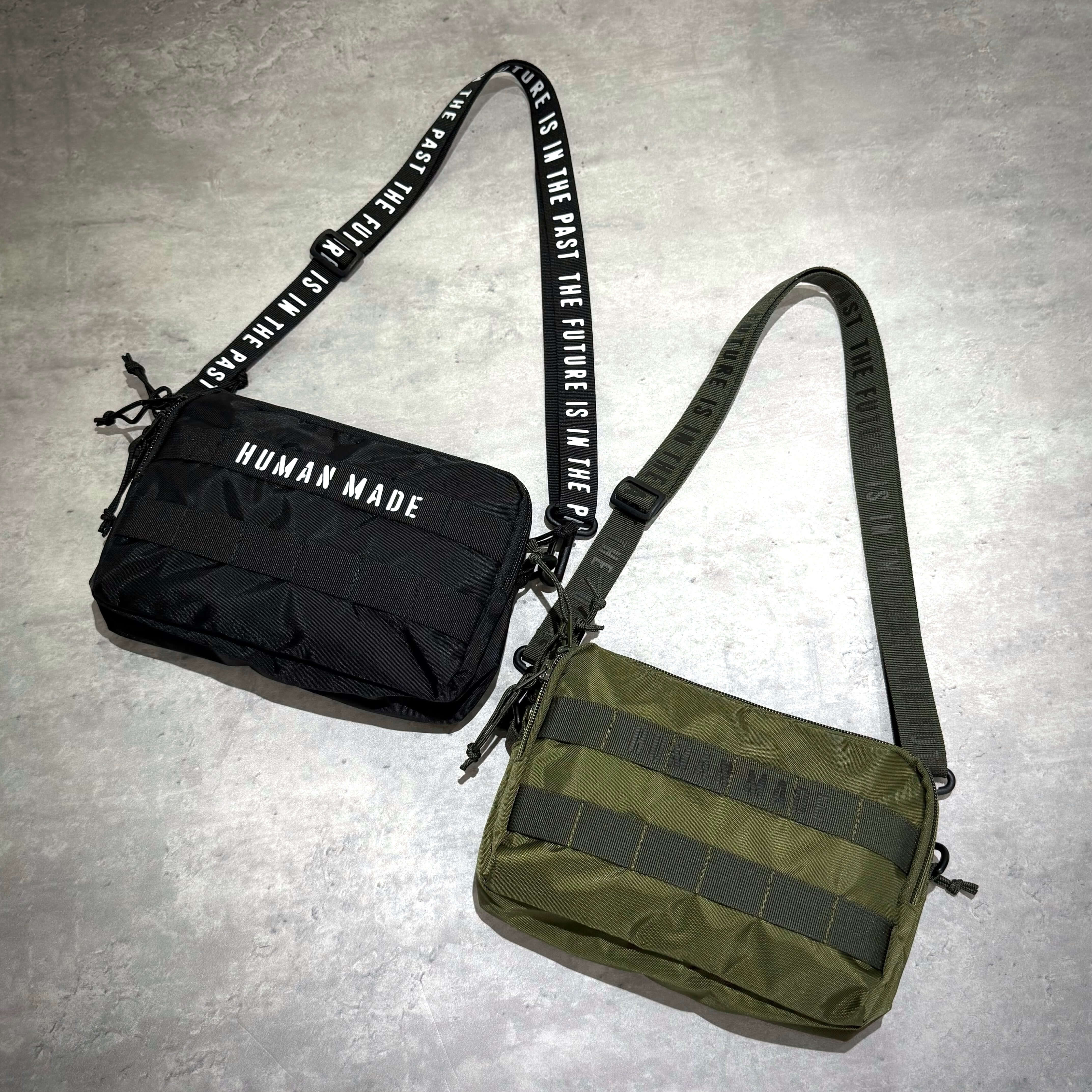 Human Made Military Pouch featuring two stylish colors, black and olive green, displayed on a neutral background.
