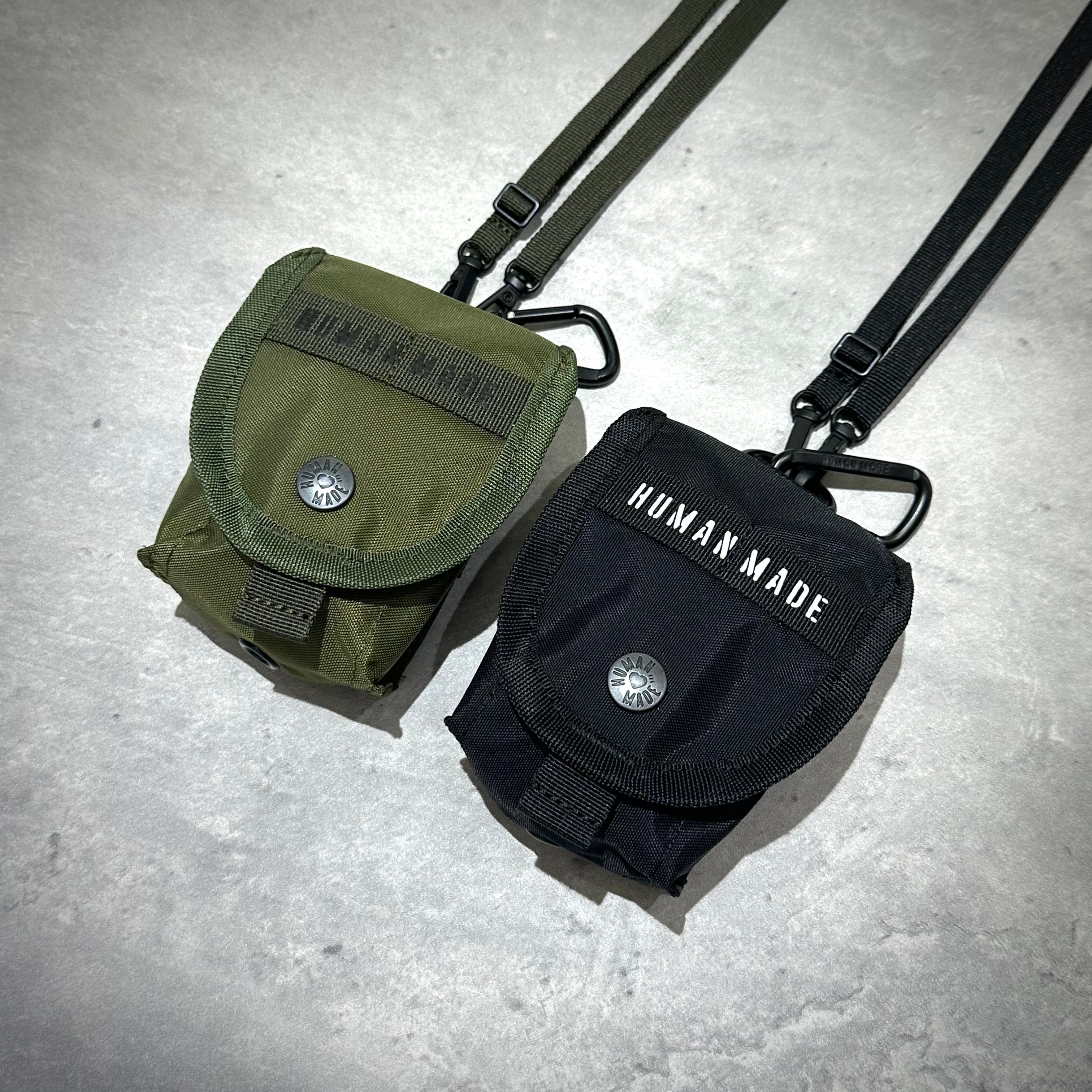 Human Made Military Multi Pouch Mini in olive green and black with adjustable straps on a gray background.