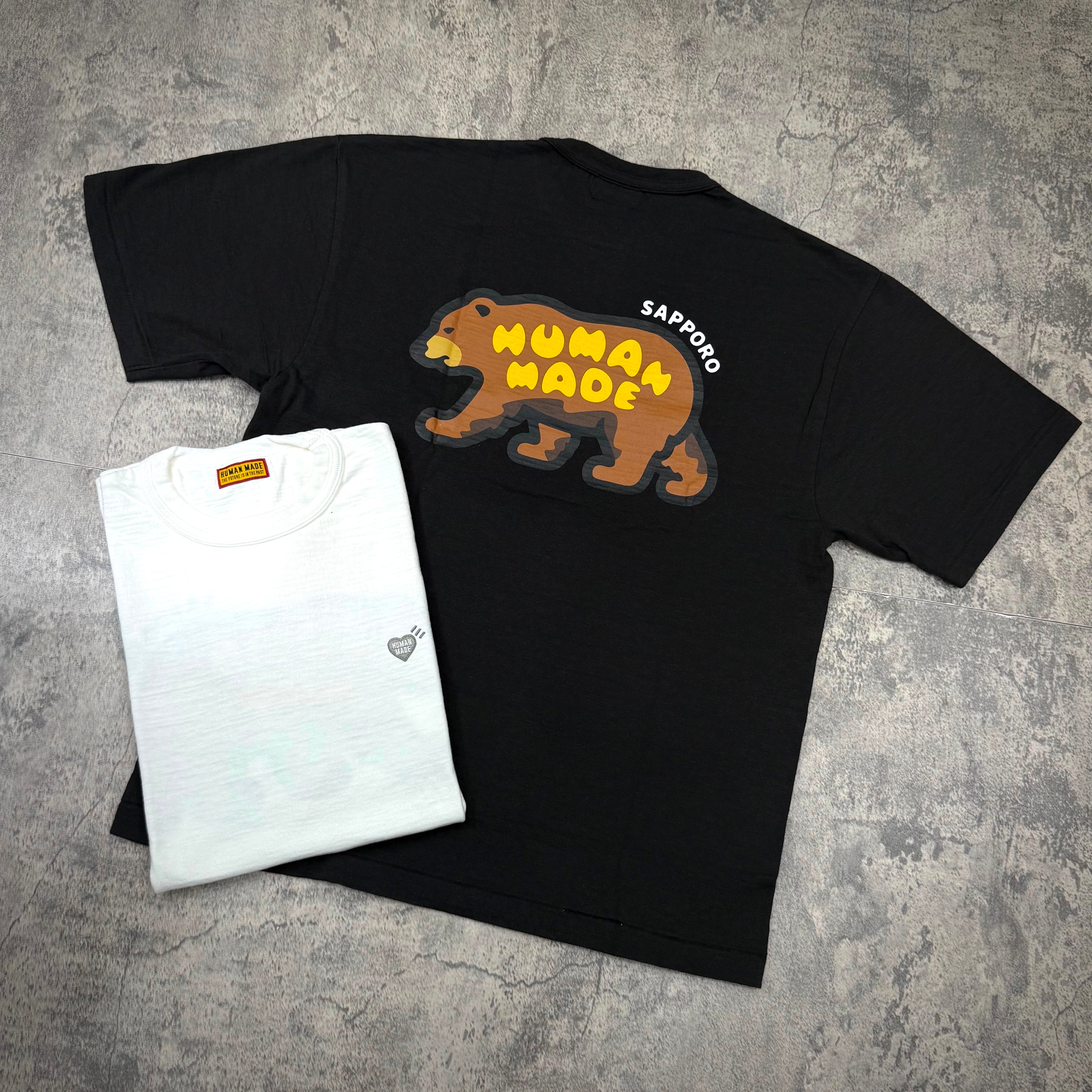 Human Made Sapporo Exclusive Bear Back Logo Tee displayed with a white tee shirt on a textured surface.