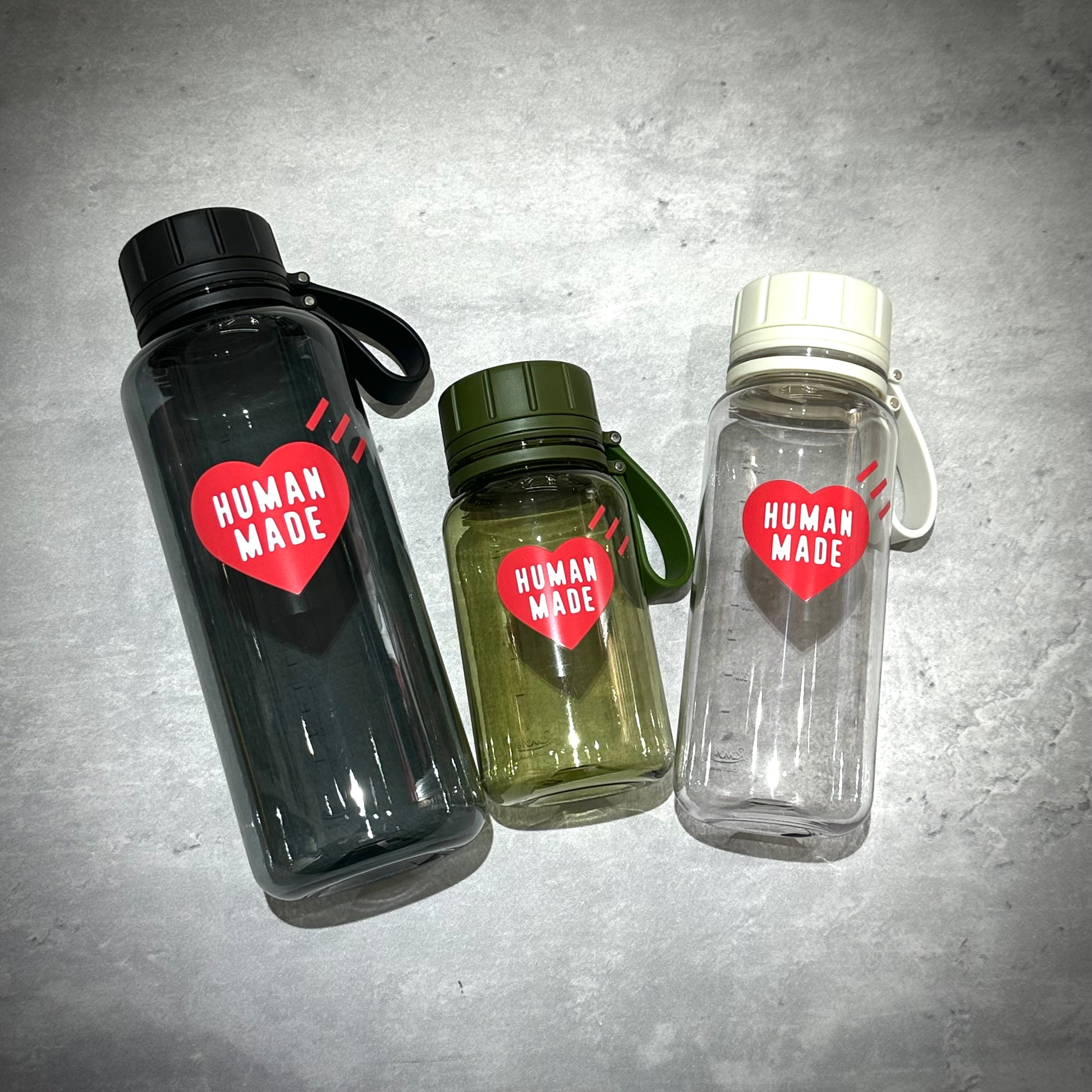 Three Human Made Water Bottles in varying sizes, featuring a heart logo with 'HUMAN MADE' text.