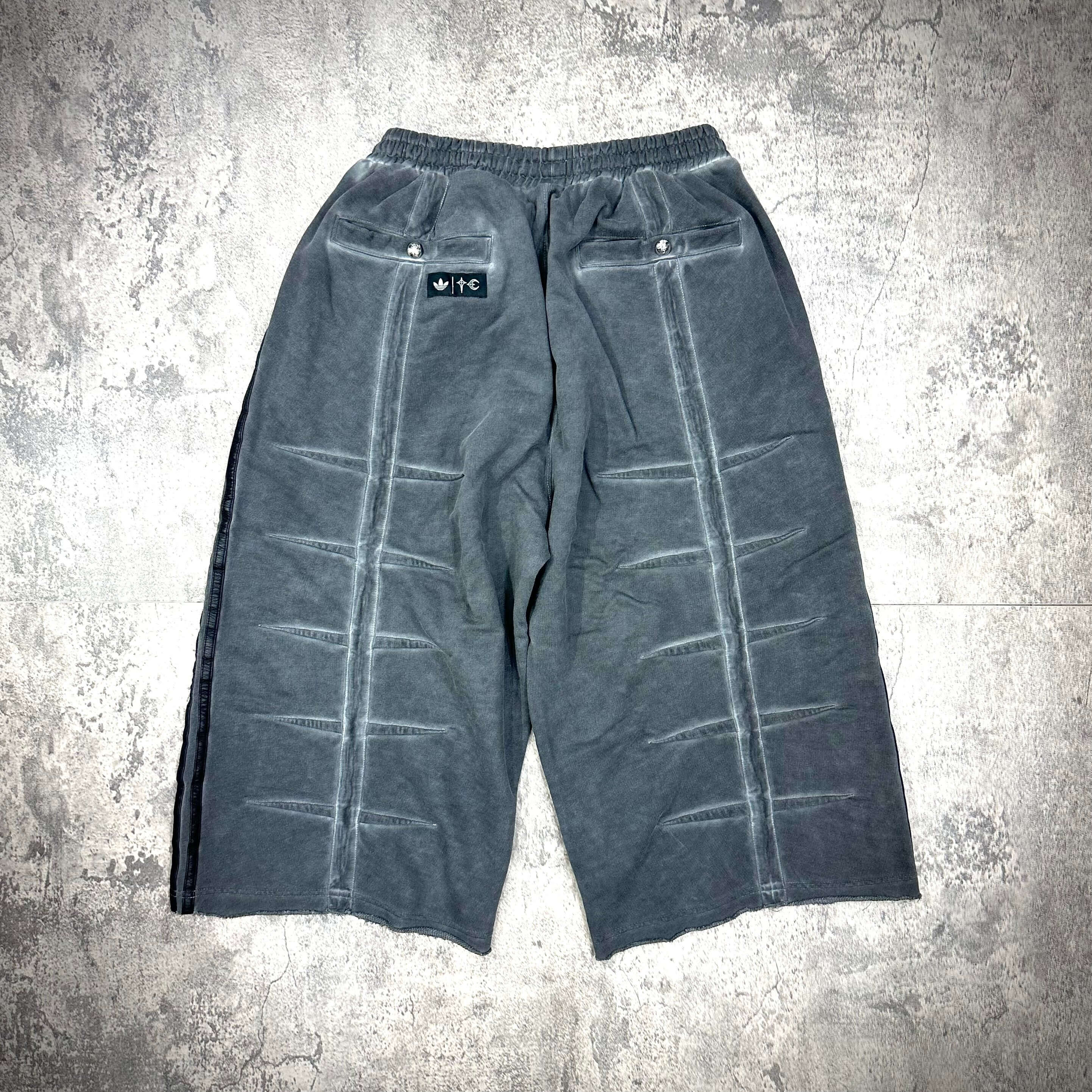 Thug Club x adidas Originals Sweat Jort featuring a unique design in gray with distinctive pleat details and logo.