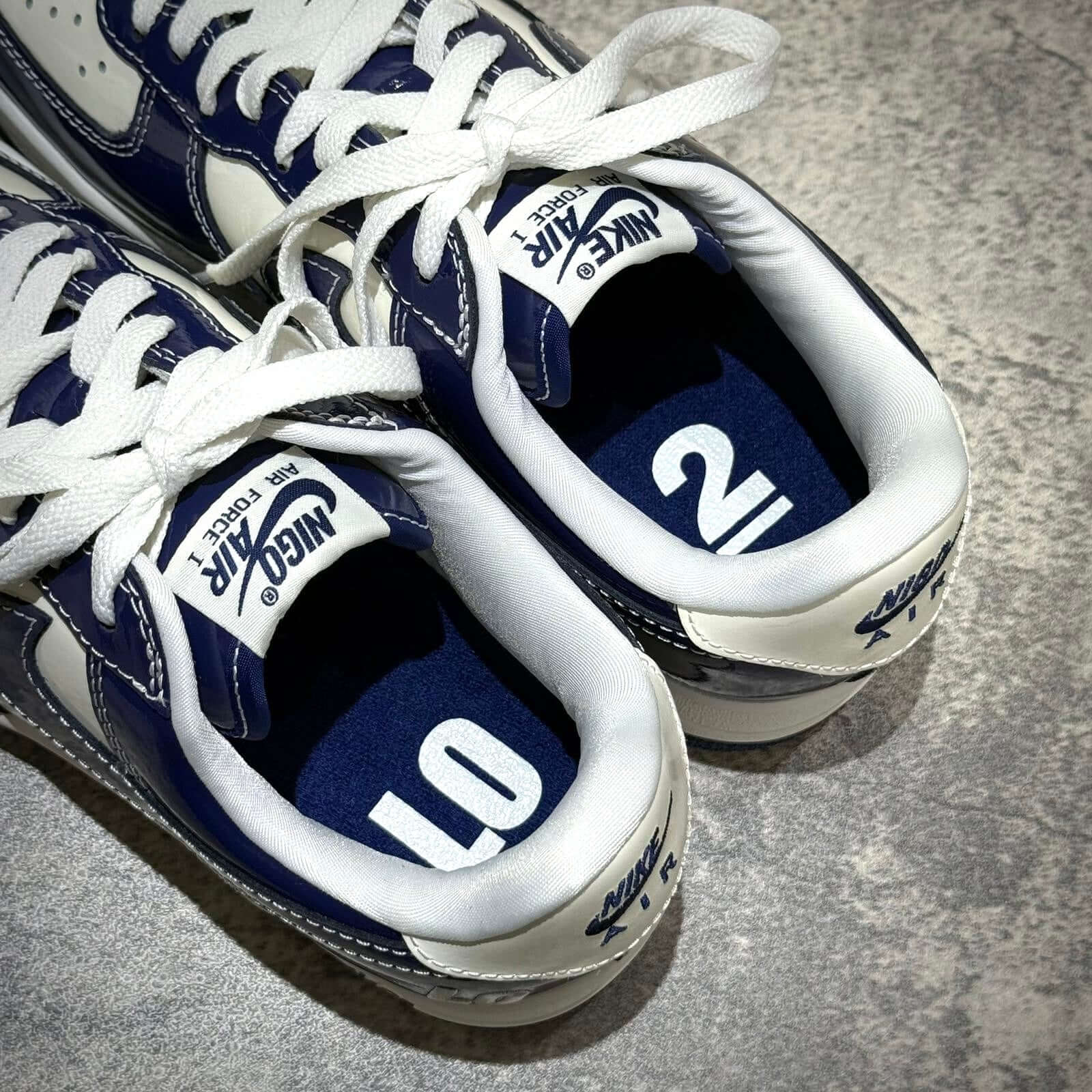 Nigo x Nike Air Force 1 LAST ORGY 2 sneakers showcasing labeled insoles with numbers 10 and 2.