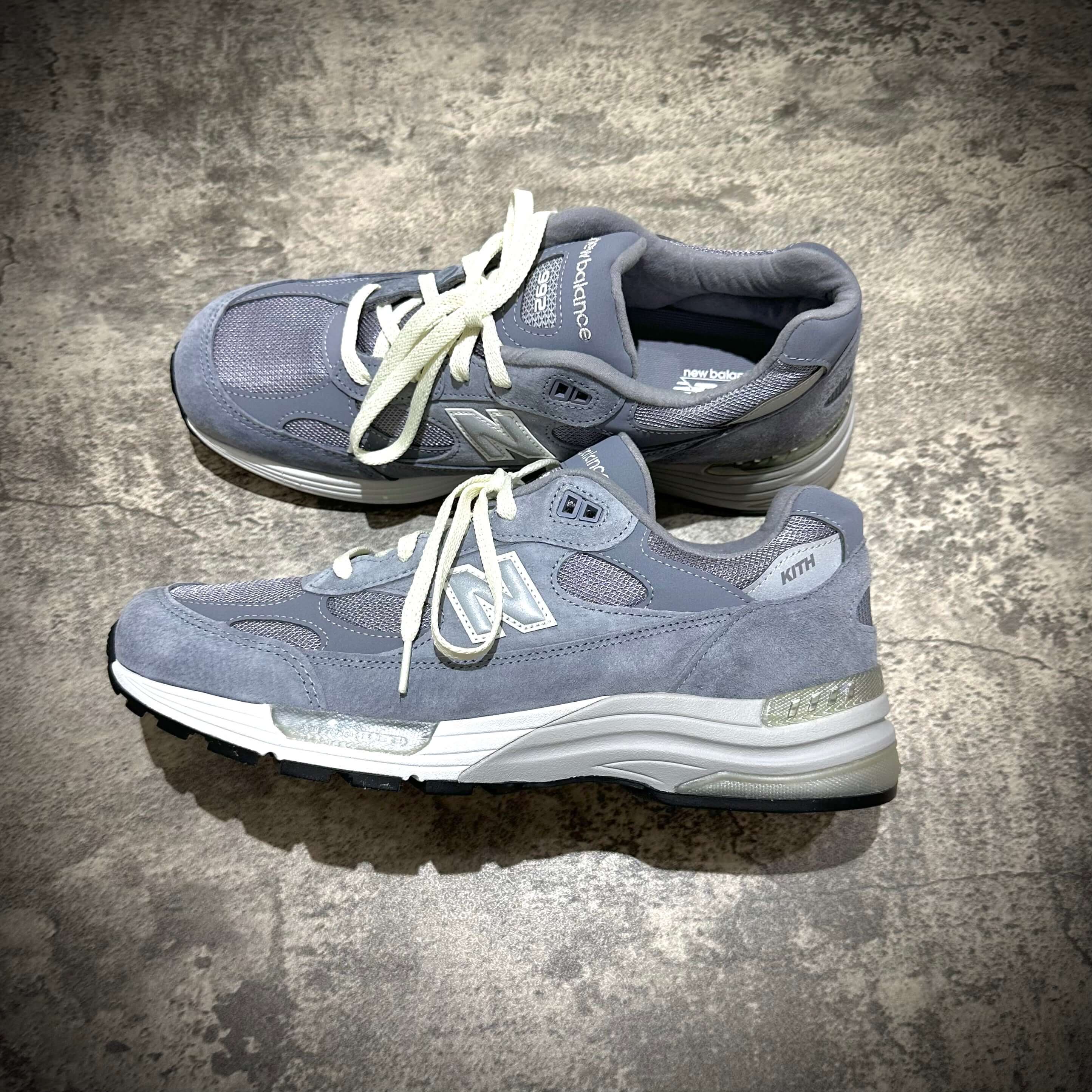 MiUSA Kith x New Balance 992 Argon sneakers in gray color, featuring laces and logo detailing.