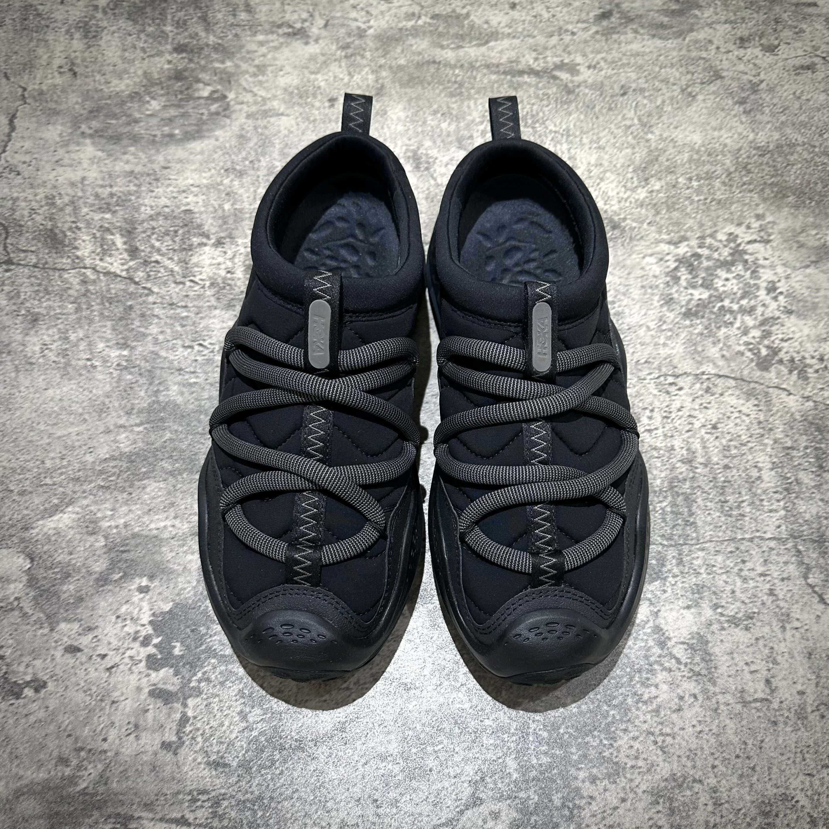 Hoka Ora Primo - Black stylish sneakers with unique lacing system and comfortable design.