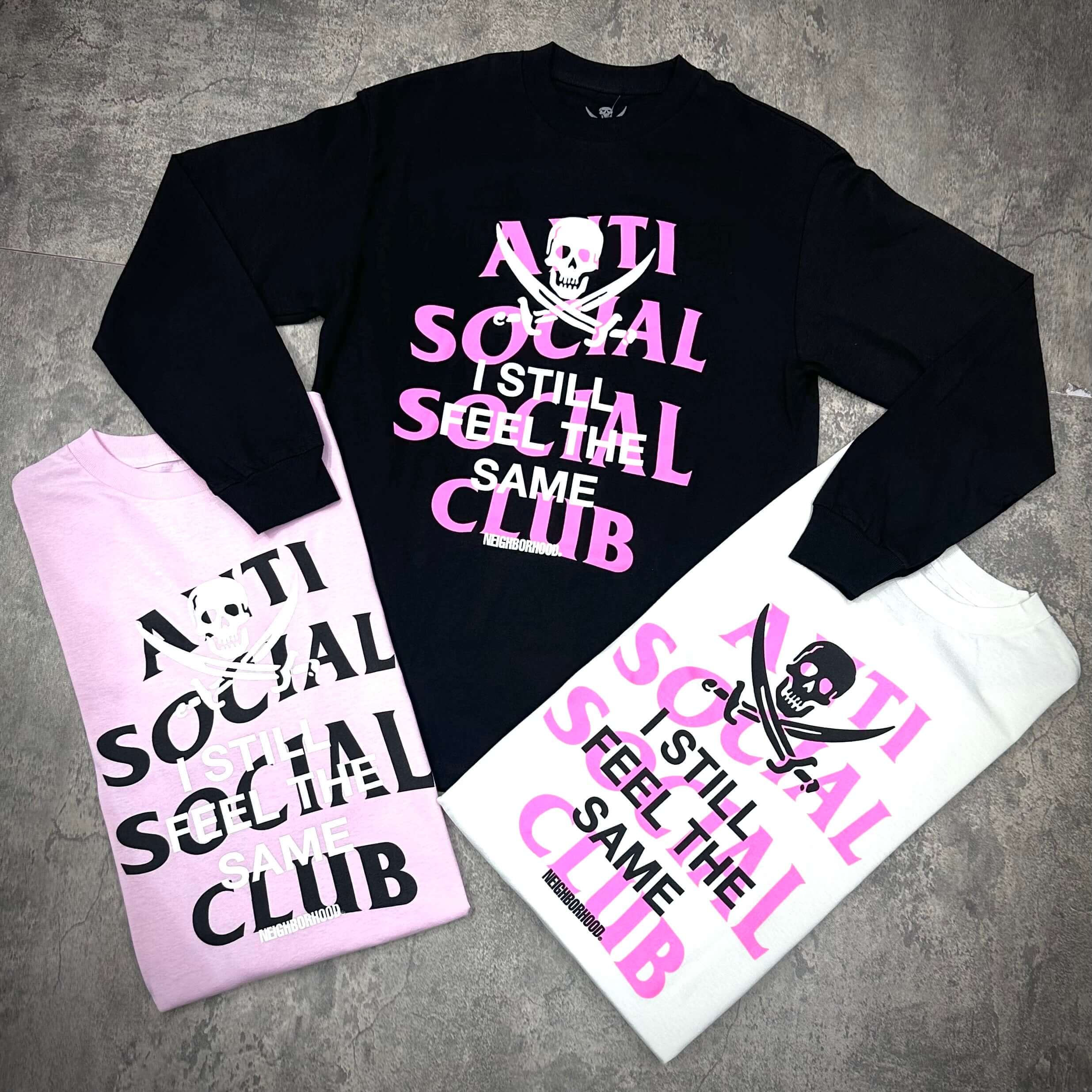 ASSC x Neighborhood Black Jack L/S Tee featuring black and pink designs, showcasing bold text against different colored backgrounds.