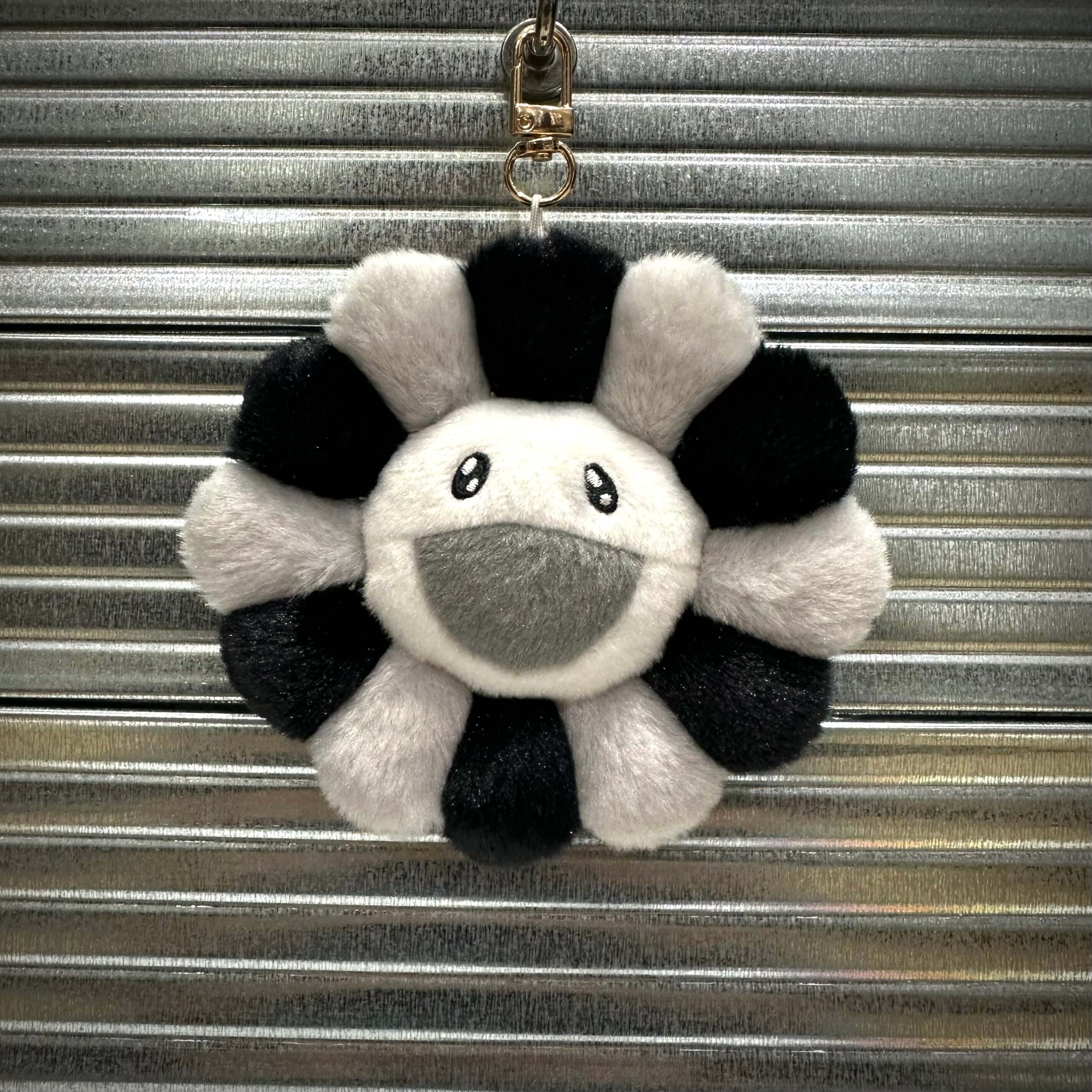 Takashi Murakami Mascot Plush Keychain 12cm featuring a cute black and white flower design with a smiling face.
