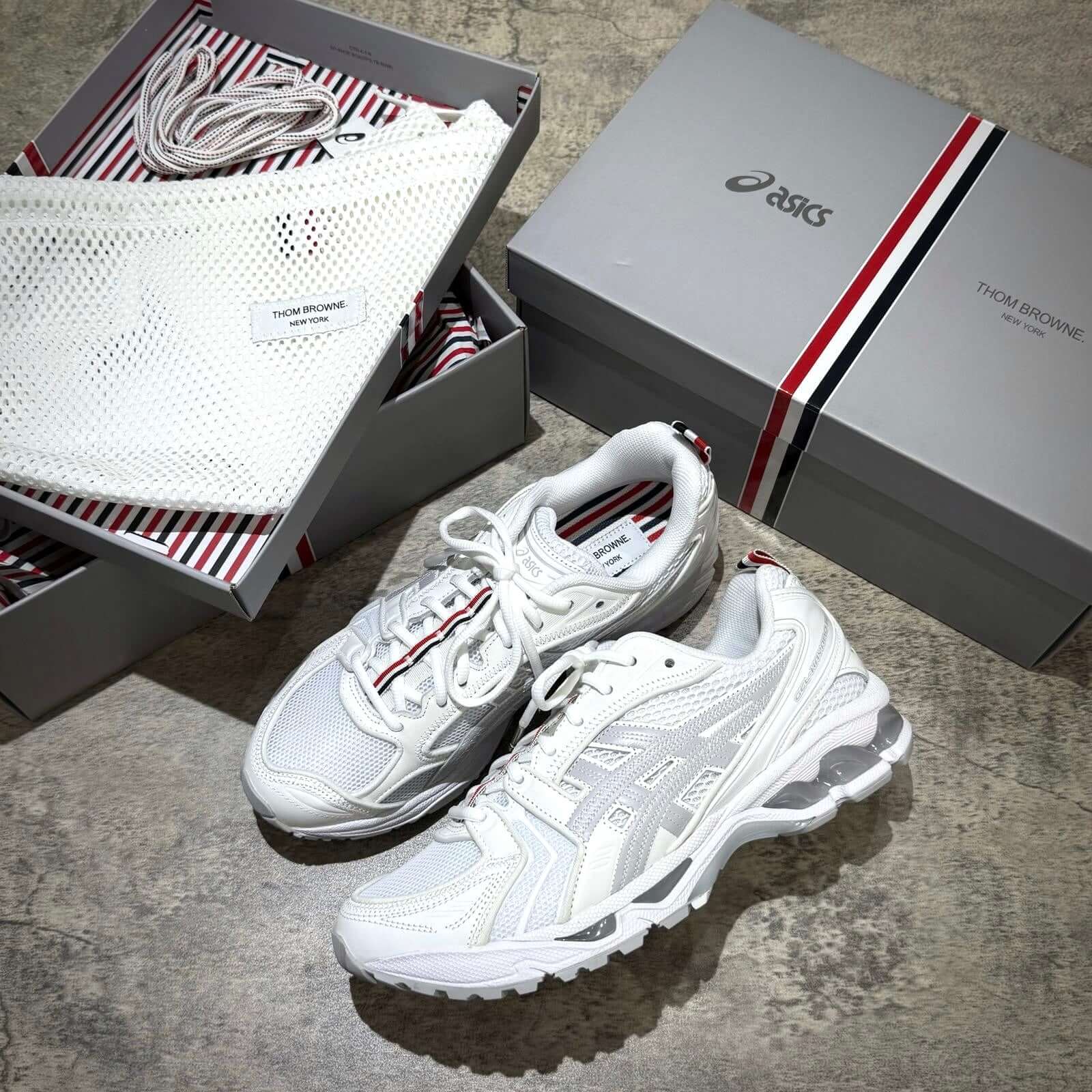 Thom Browne x Asics Gel-Kayano 14 - White sneakers with packaging and accessories.