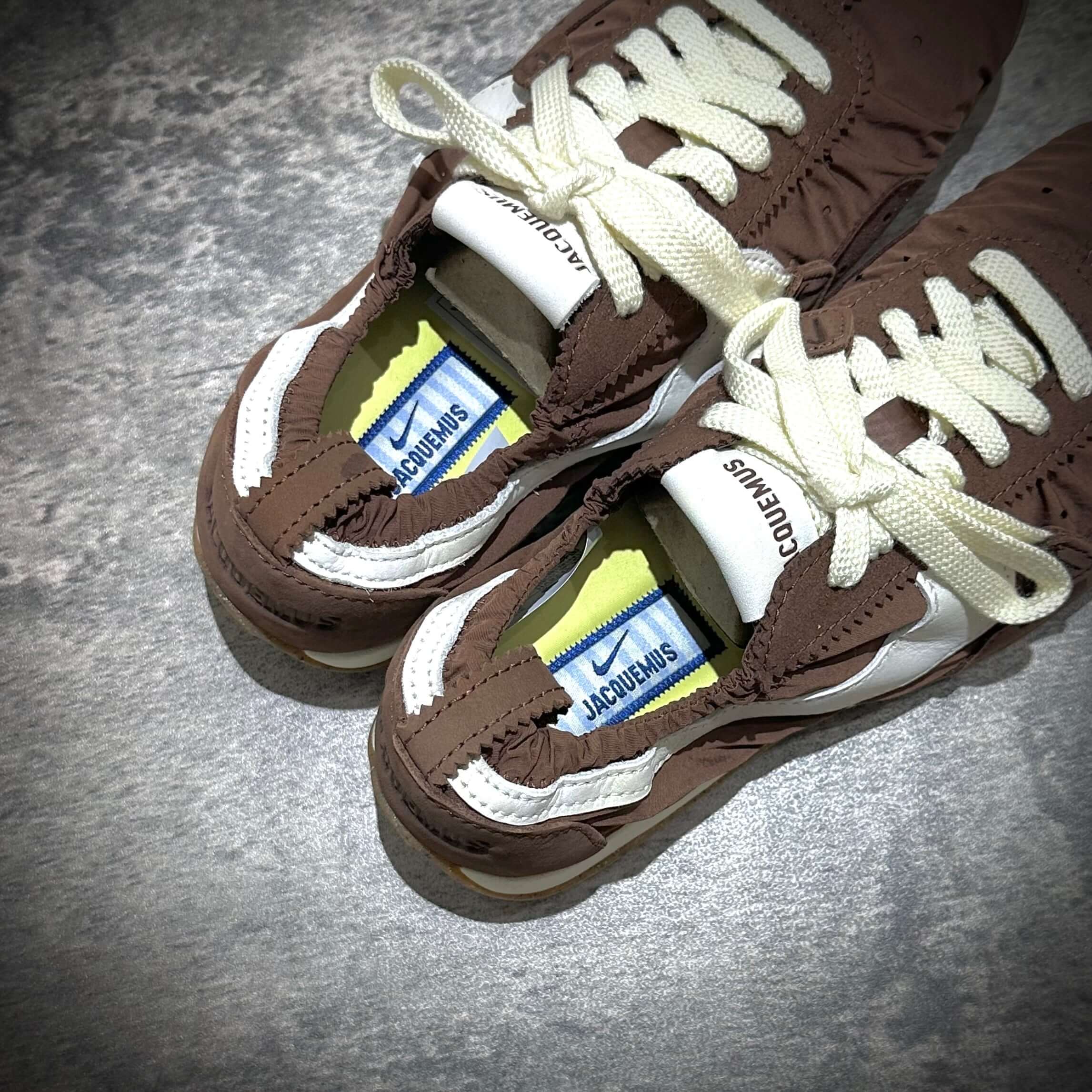 Jacquemus x Nike Moon Shoe SP - Brown, top view of sneaker showing laces and brand tags.
