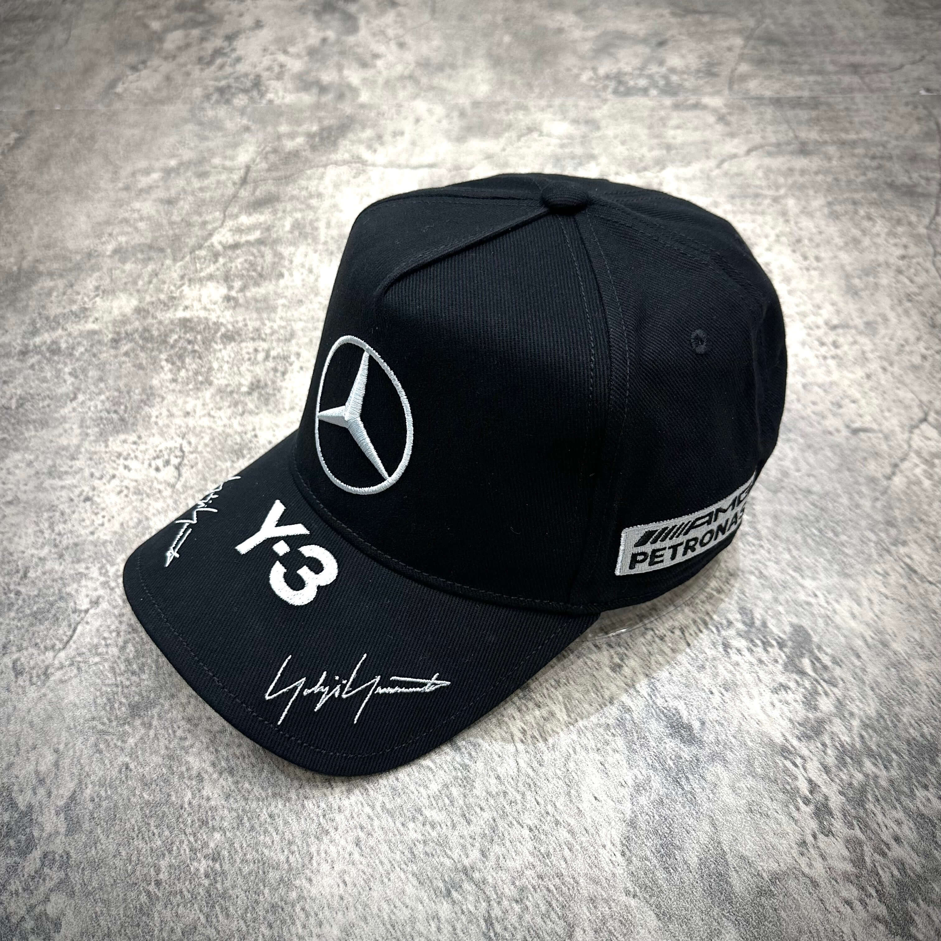 Y-3 x Mercedes AMG Petronas F1 Podium Cap in Black and Grey, featuring logo and signatures.