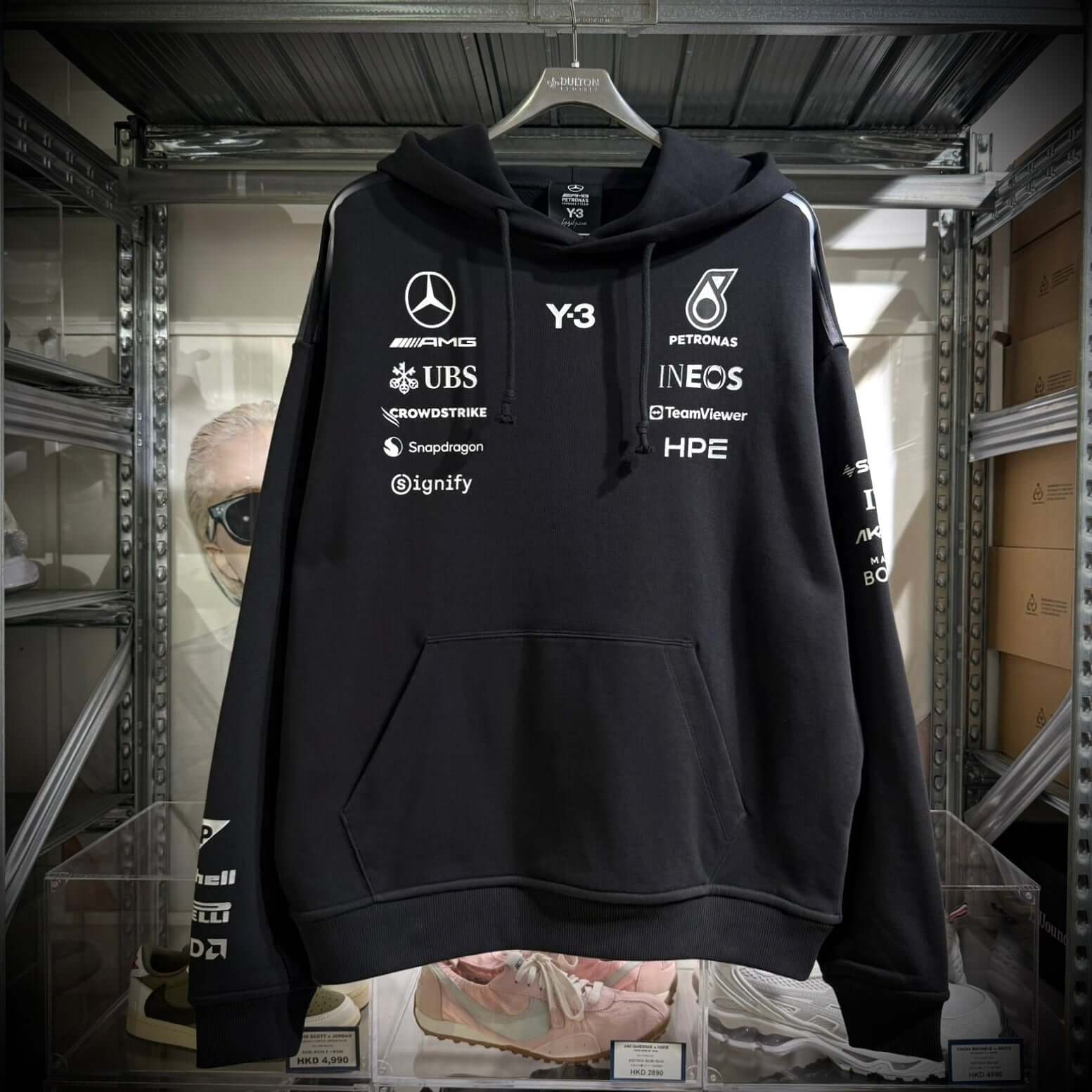 Y-3 x Mercedes AMG Petronas F1 Hoodie featuring logos of sponsors and brands on a black background.