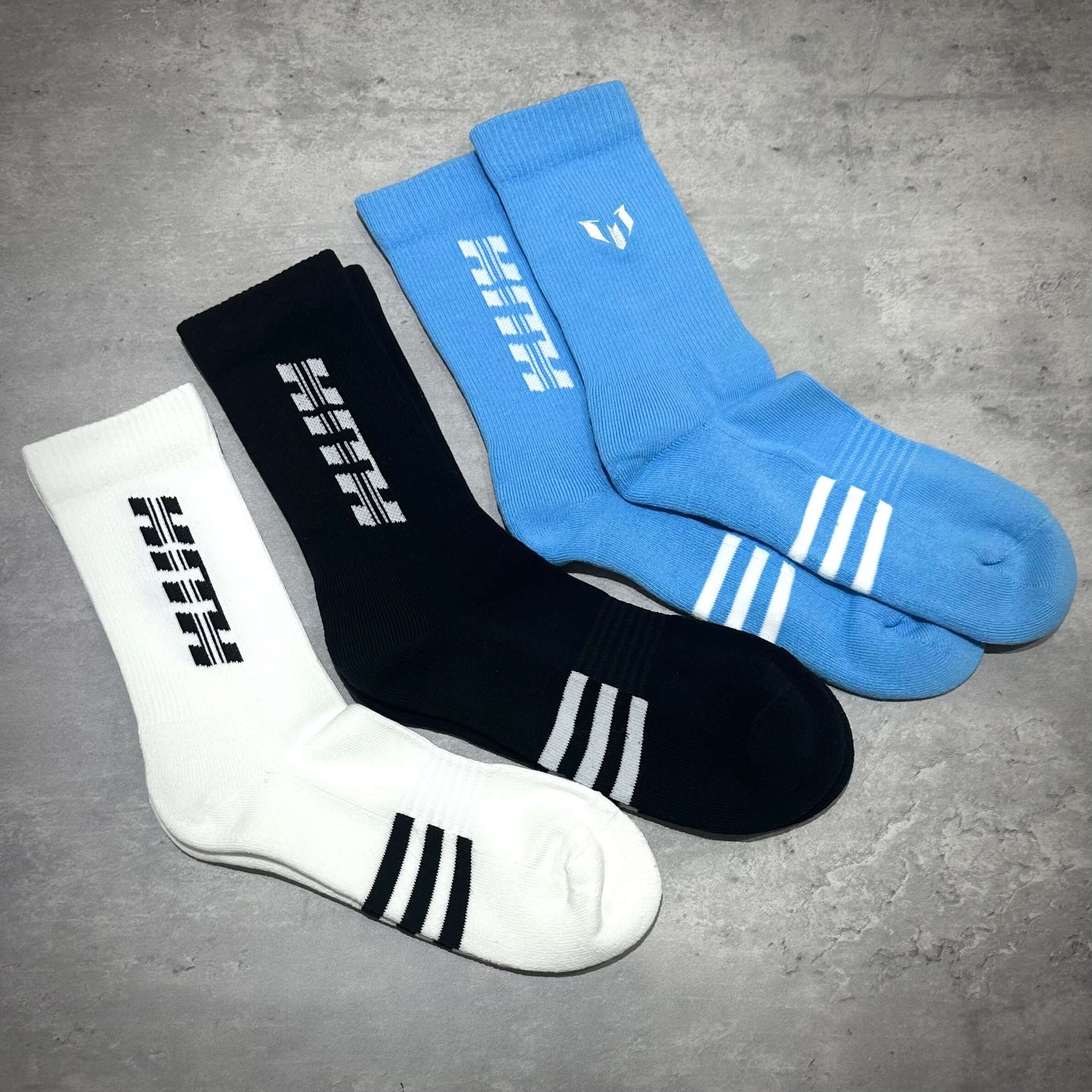 KITH x MESSI for adidas Football 3-Pair Crew Socks in white, black, and blue colors displayed.