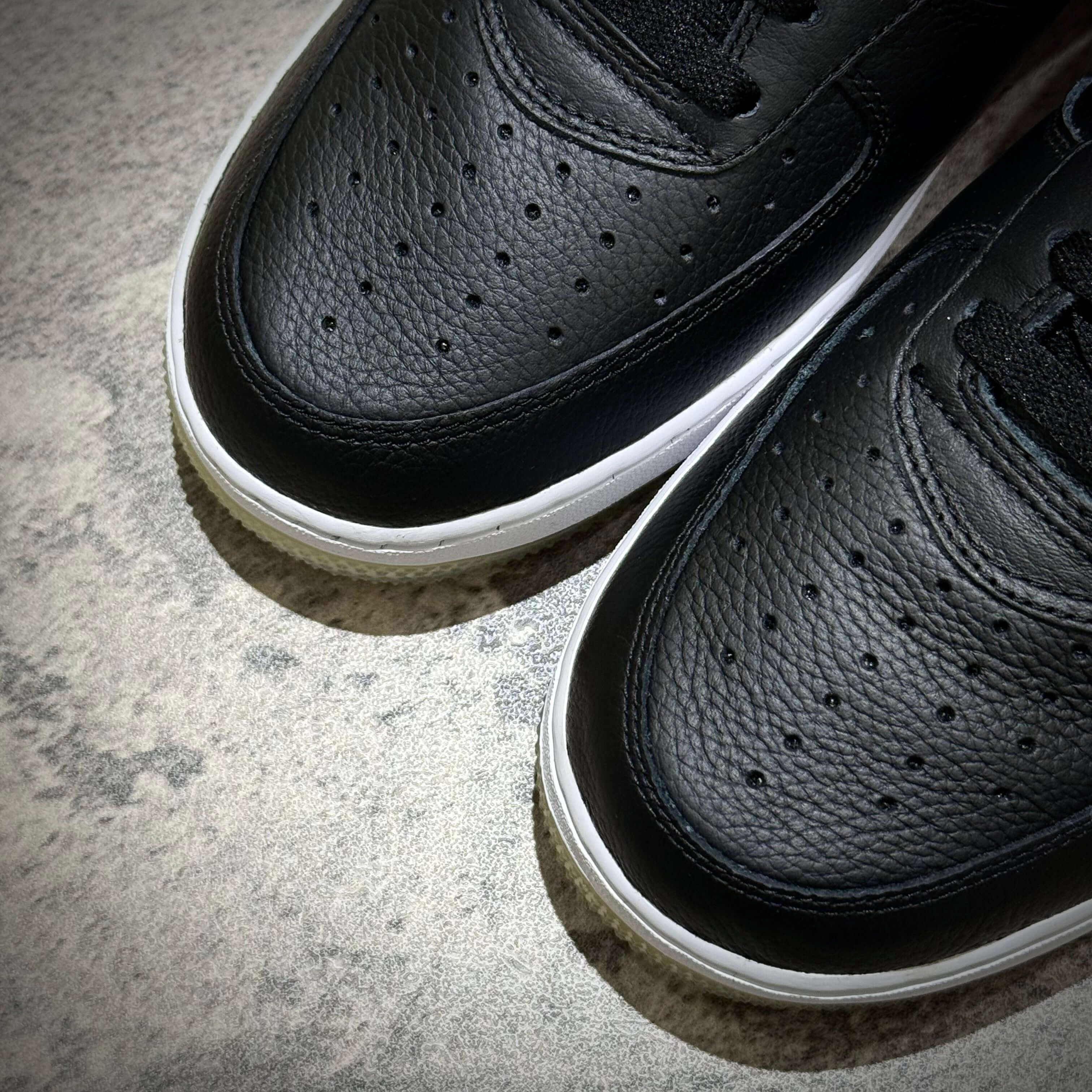 KITH x Nike Air Force 1 Low Knicks black leather sneakers close-up view