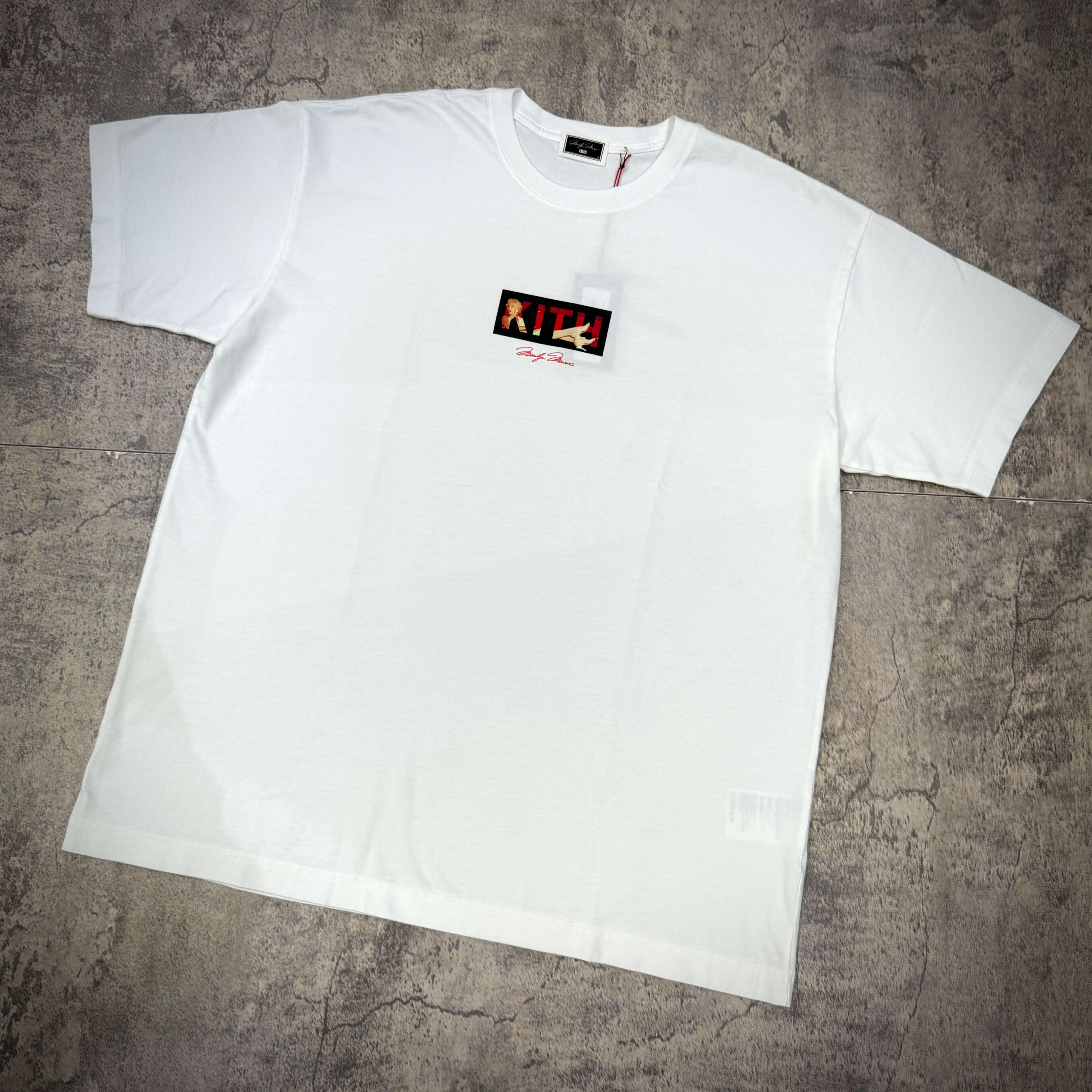 Kith for Marilyn Monroe Seven Year Classic Logo Tee displayed on a textured surface in white color.