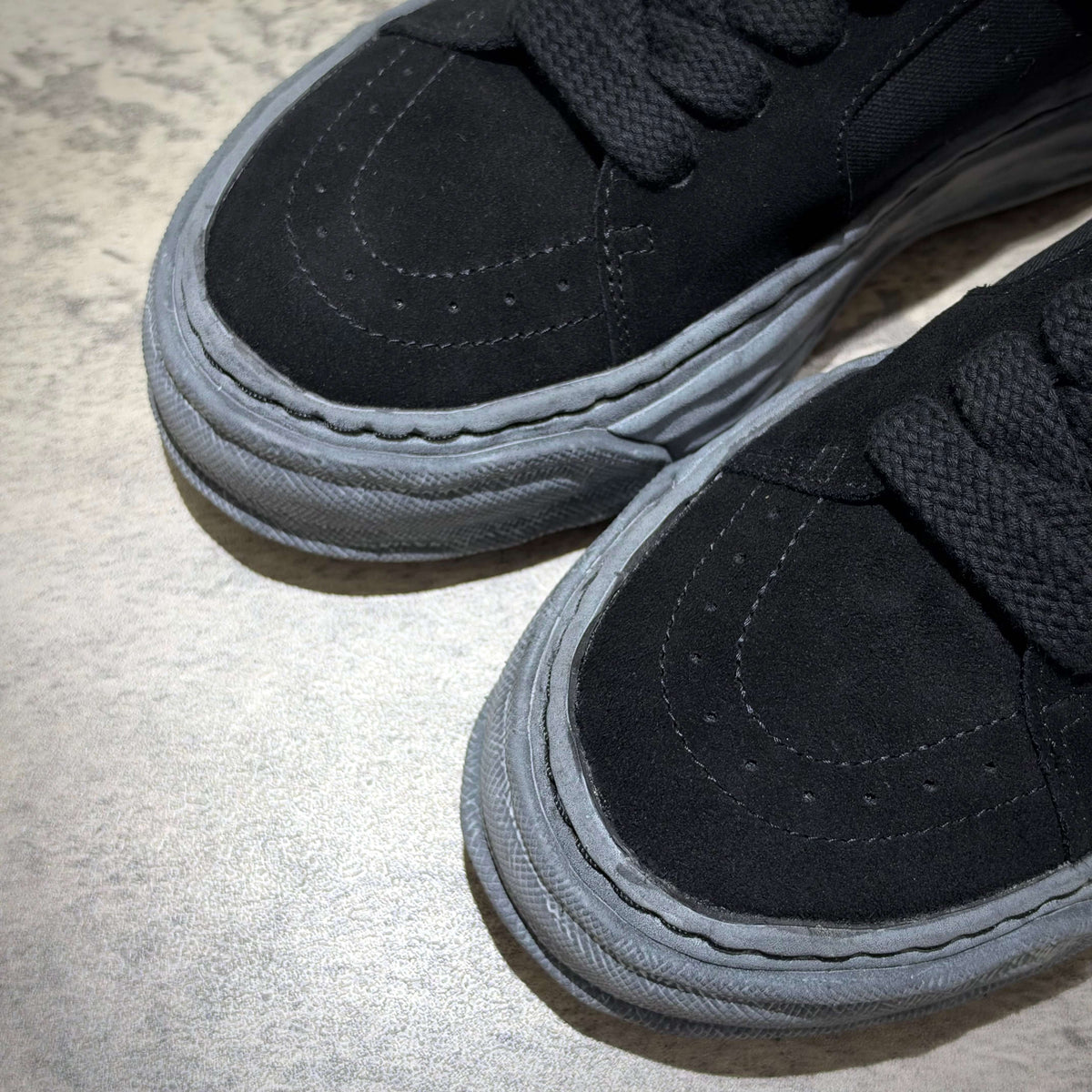 MMY Eric Overdyed Canvas - All Black sneakers close-up view showcasing black suede and grey soles.