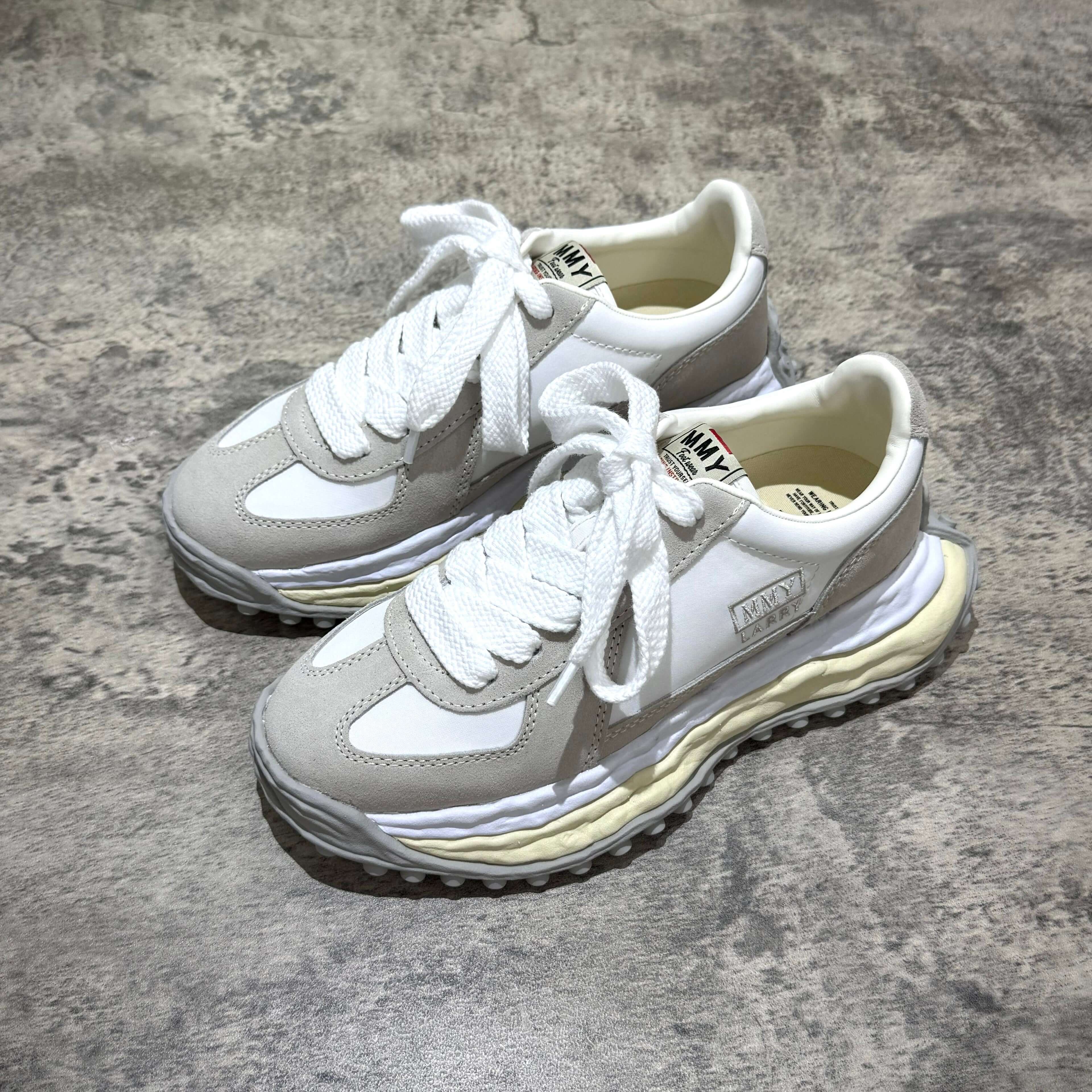 MMY Larry Leather Low - White sneakers with oversized design and lace-up closure.