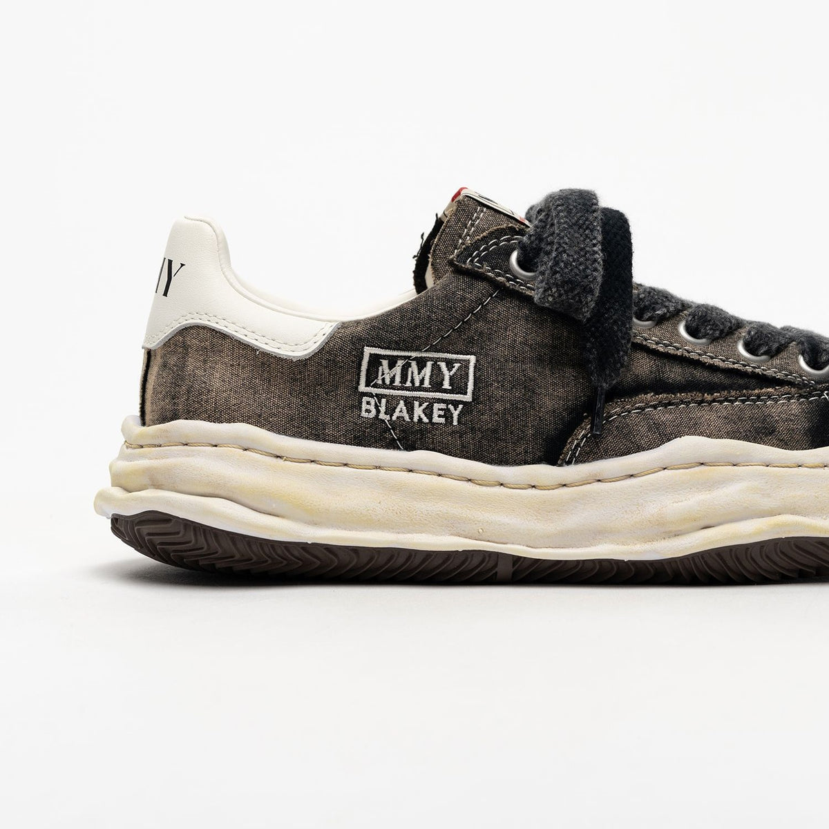 MMY Blakey Bleached Canvas Low - Black side view with details of the design, including branding and texture.