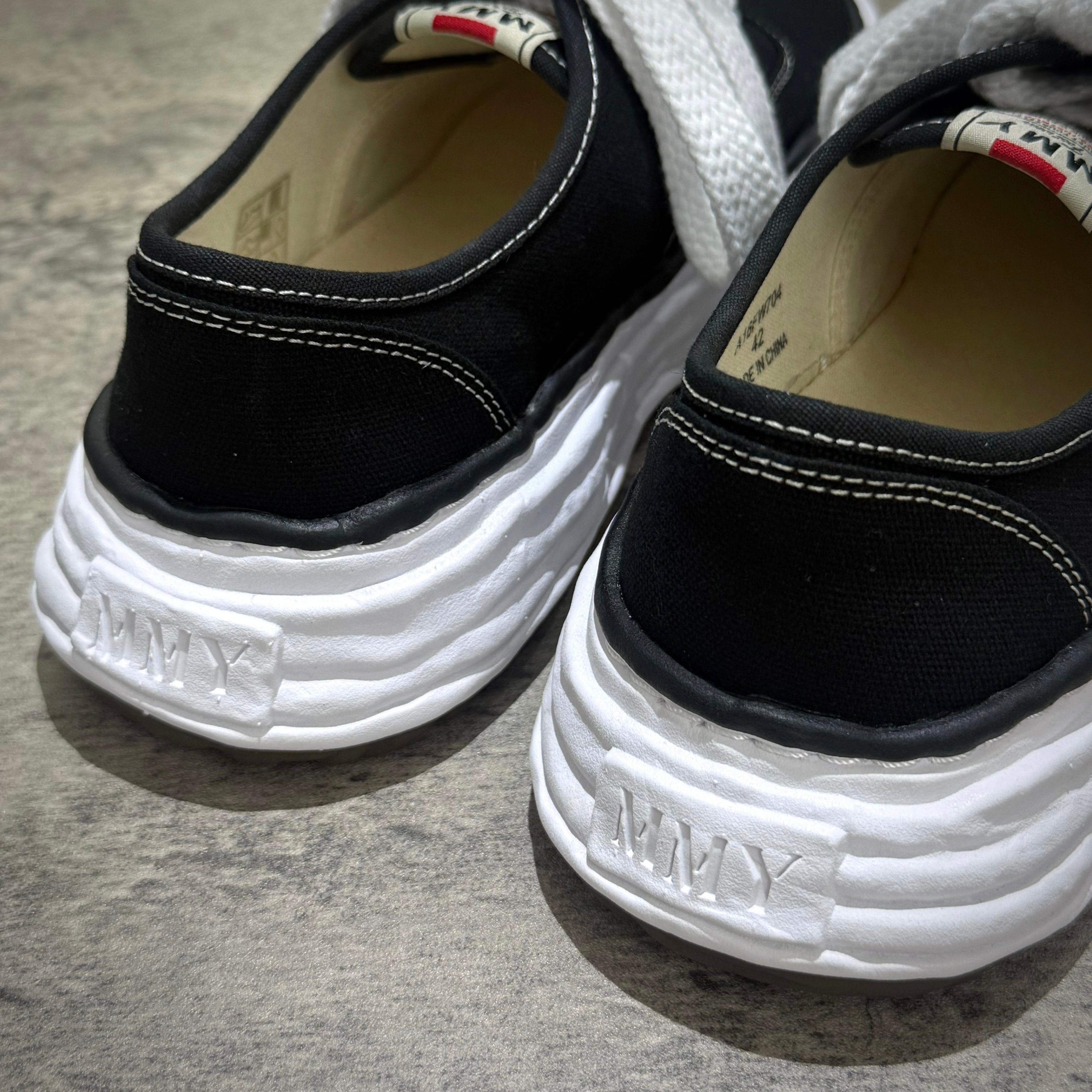 Detail of MMY Baker26 Canvas Low - Black shoes showing the rear design and stitching.