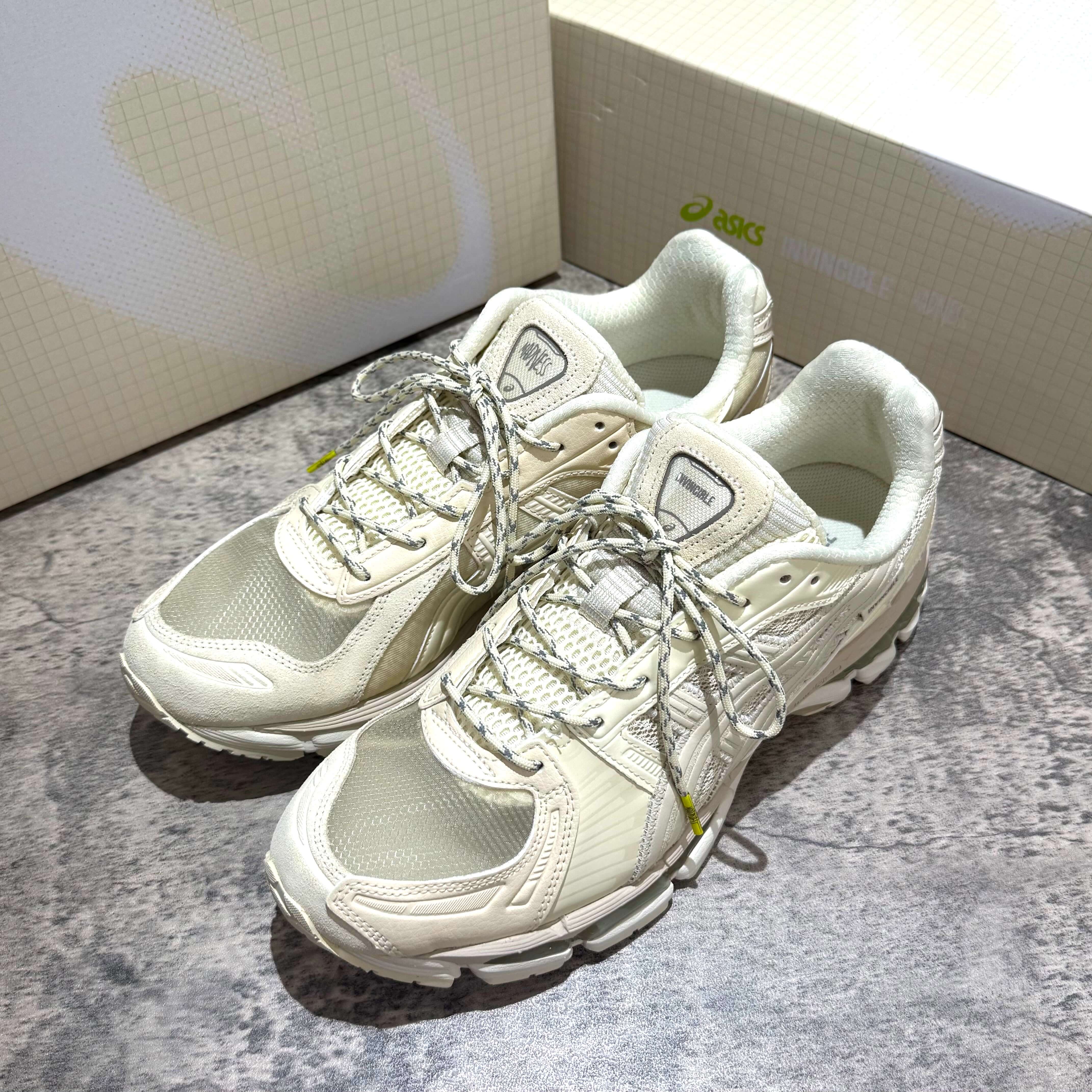 Madness x Invincible x Asics Gel-Kayano 12.1 Vanilla sneakers with grey laces and intricate design.