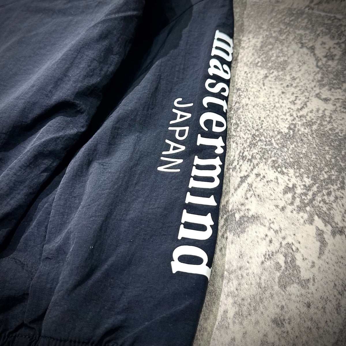 Mastermind Japan x Bonera Stretch Anthem Jacket close-up showing logo detail on sleeve.