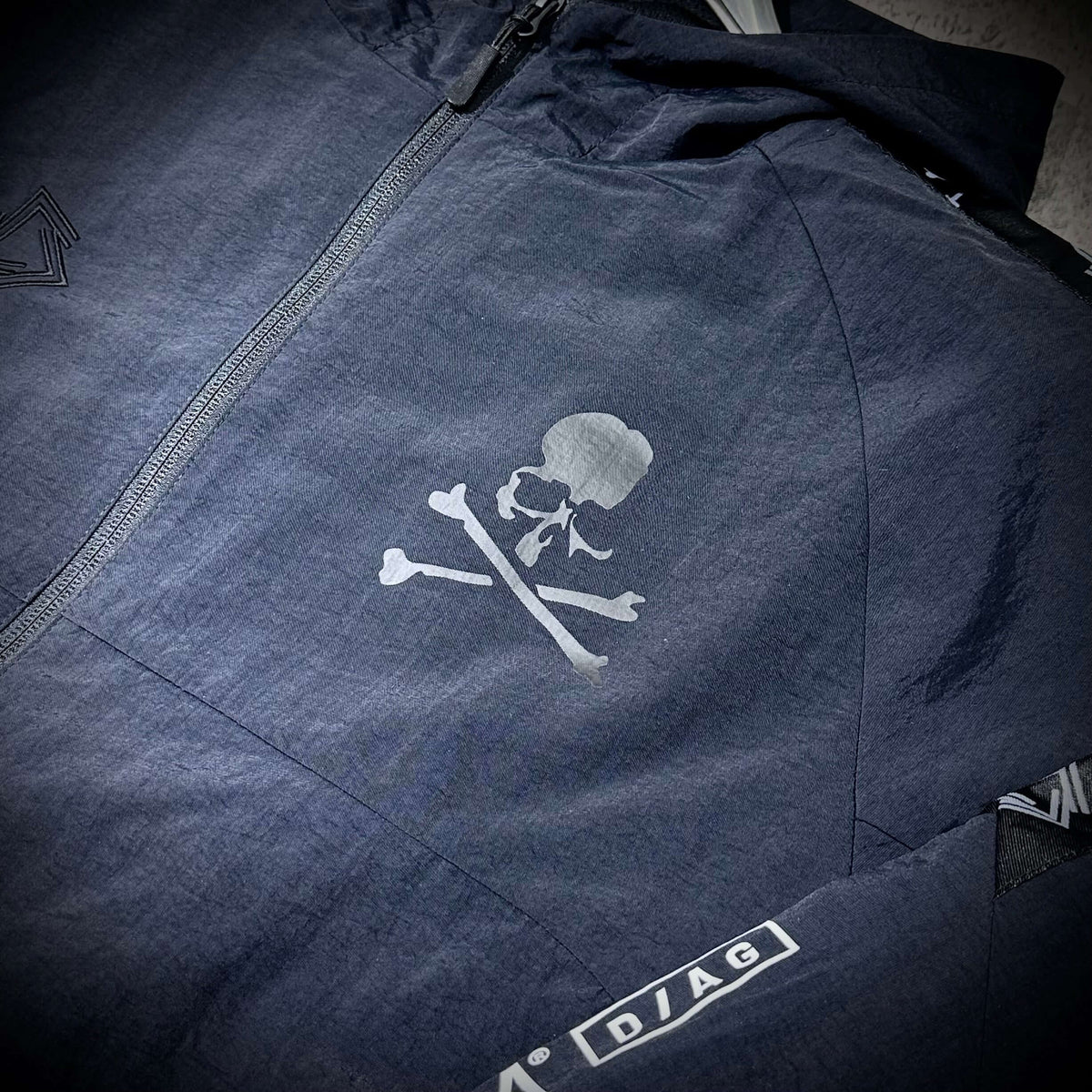 Mastermind Japan x Bonera Stretch Anthem Jacket featuring a skull and crossbones design on a dark fabric.